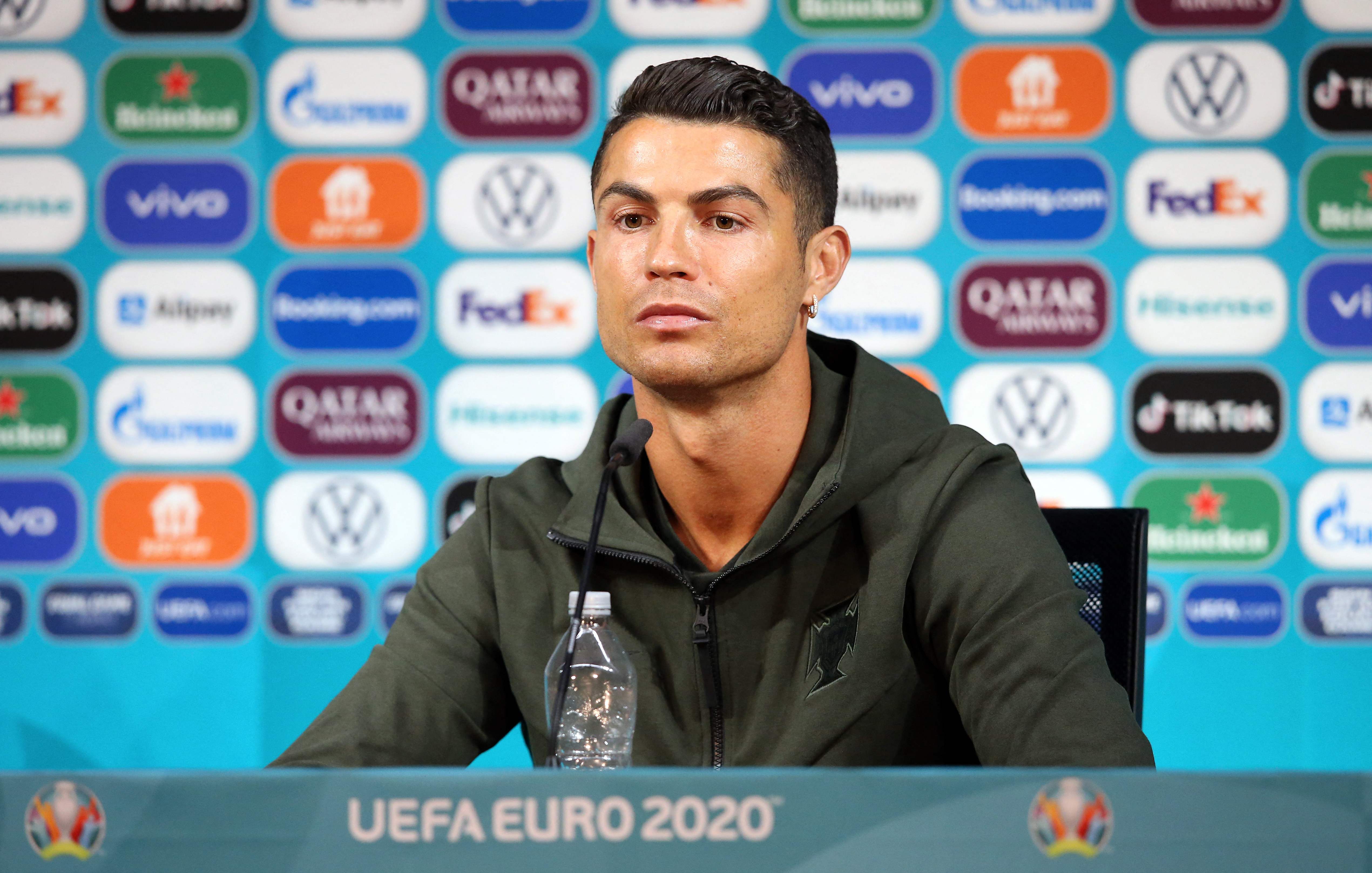 In this handout picture taken and released on June 14, 2021 by UEFA, Portugal's forward Cristiano Ronaldo gives an MD-1 press conference at the Puskas Arena in Budapest, on the eve of the UEFA EURO 2020 football match between Hungary and Portugal. (Photo by Handout / UEFA / AFP) / RESTRICTED TO EDITORIAL USE - MANDATORY CREDIT 
