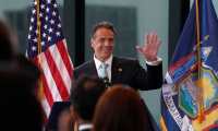 New York Governor  Andrew Cuomo waves during an event to announce that New York will lift 'virtually all' Covid-19 restrictions, after the state cleared the threshold of 70 percent vaccinated,  at One World Trade Center in New York on June 15, 2021 (Photo by TIMOTHY A. CLARY / AFP)
