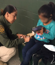 Foto de archivo de una agente de la CBP habla con una niña guatemalteca que se llegó a la frontera sur de EE. UU. (Foto Prensa Libre: CBP)