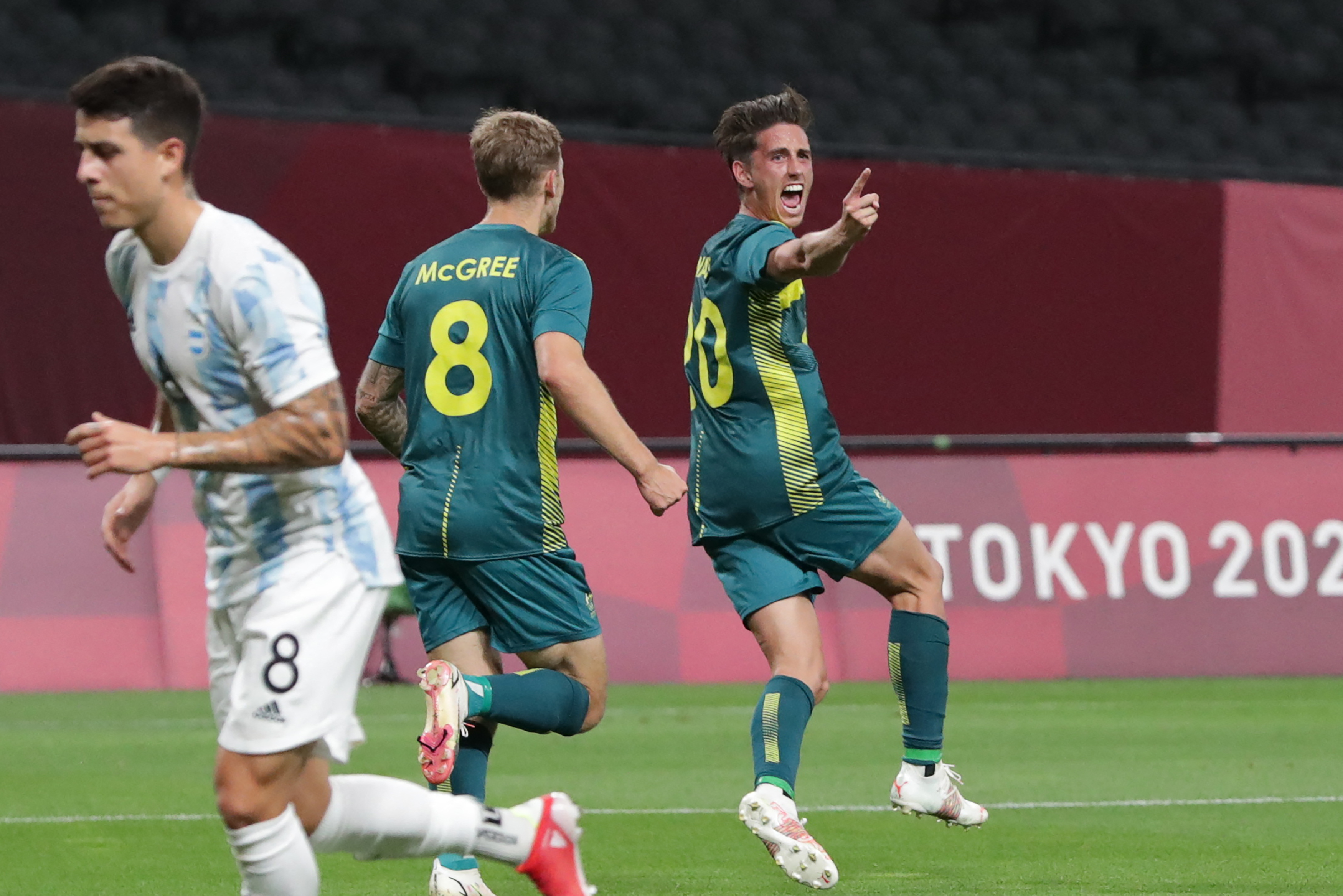 Australia's Lachlan Wales (C) celebrates scoring during the Tokyo 2020 Olympic Games men's group C first round football match between Argentina and Australia at the Sapporo Dome in Sapporo on July 22, 2021. (Photo by ASANO IKKO / AFP)