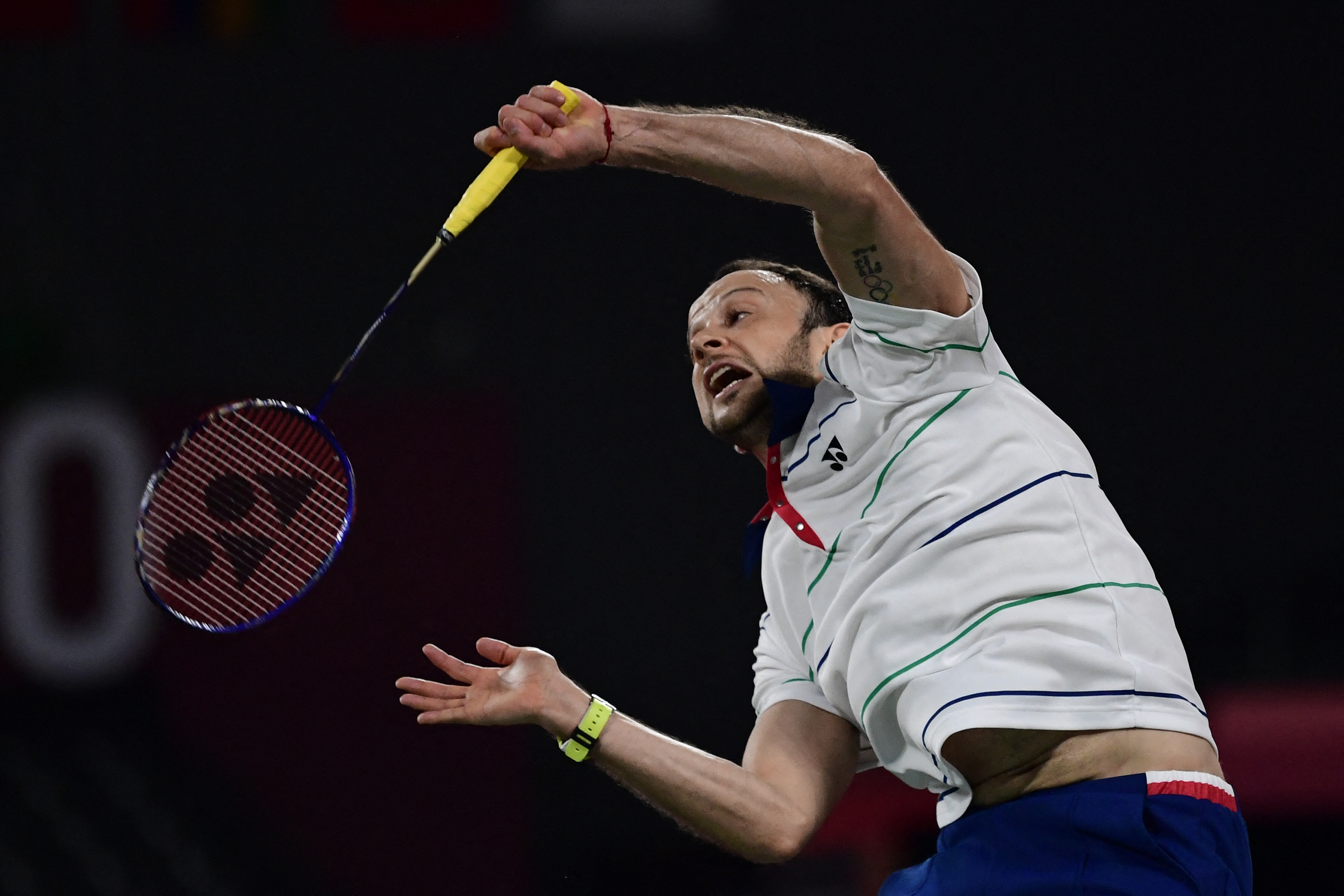 Guatemala's Kevin Cordon hits a shot to Mexico's Lino Munoz in their men's singles badminton group stage match during the Tokyo 2020 Olympic Games at the Musashino Forest Sports Plaza in Tokyo on July 26, 2021. (Photo by Pedro PARDO / AFP)