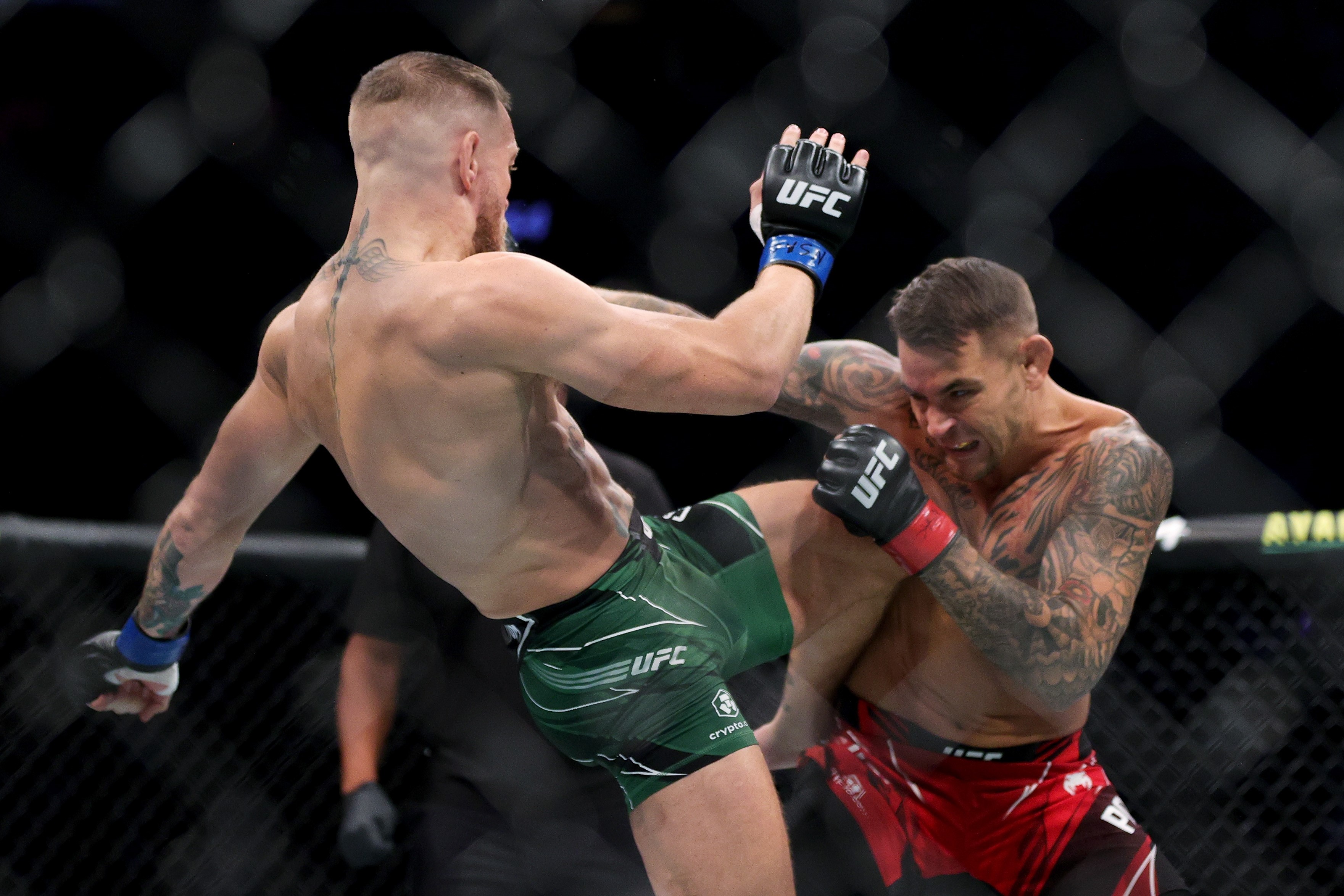LAS VEGAS, NEVADA - JULY 10: Conor McGregor of Ireland lands a knee on Dustin Poirier in the first round in their lightweight bout during UFC 264: Poirier v McGregor 3 at T-Mobile Arena on July 10, 2021 in Las Vegas, Nevada. Stacy Revere/Getty Images/AFP == FOR NEWSPAPERS, INTERNET, TELCOS & TELEVISION USE ONLY ==