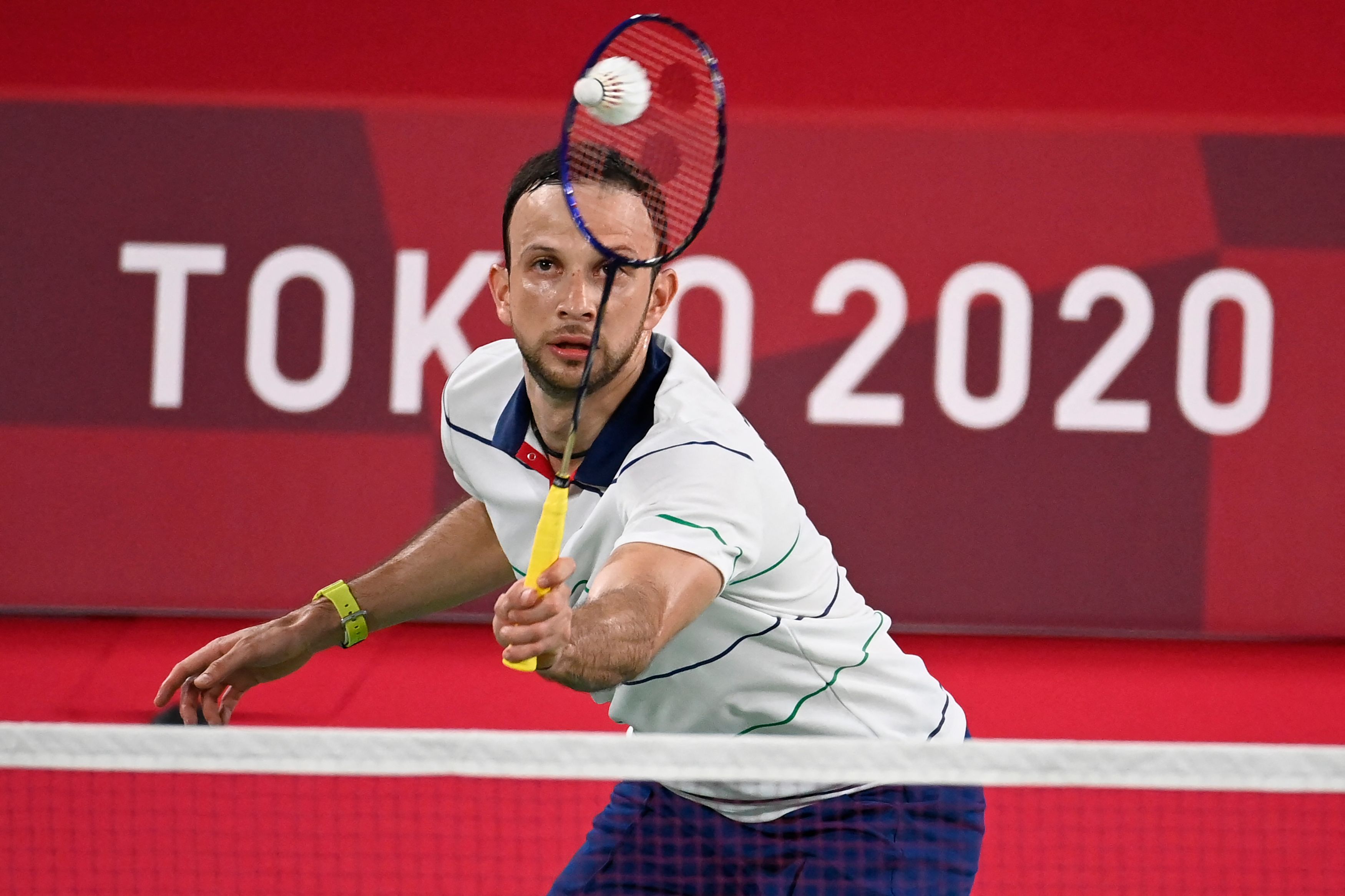 Guatemala's Kevin Cordon hits a shot to Mexico's Lino Munoz in their men's singles badminton group stage match during the Tokyo 2020 Olympic Games at the Musashino Forest Sports Plaza in Tokyo on July 26, 2021. (Photo by Alexander NEMENOV / AFP)
