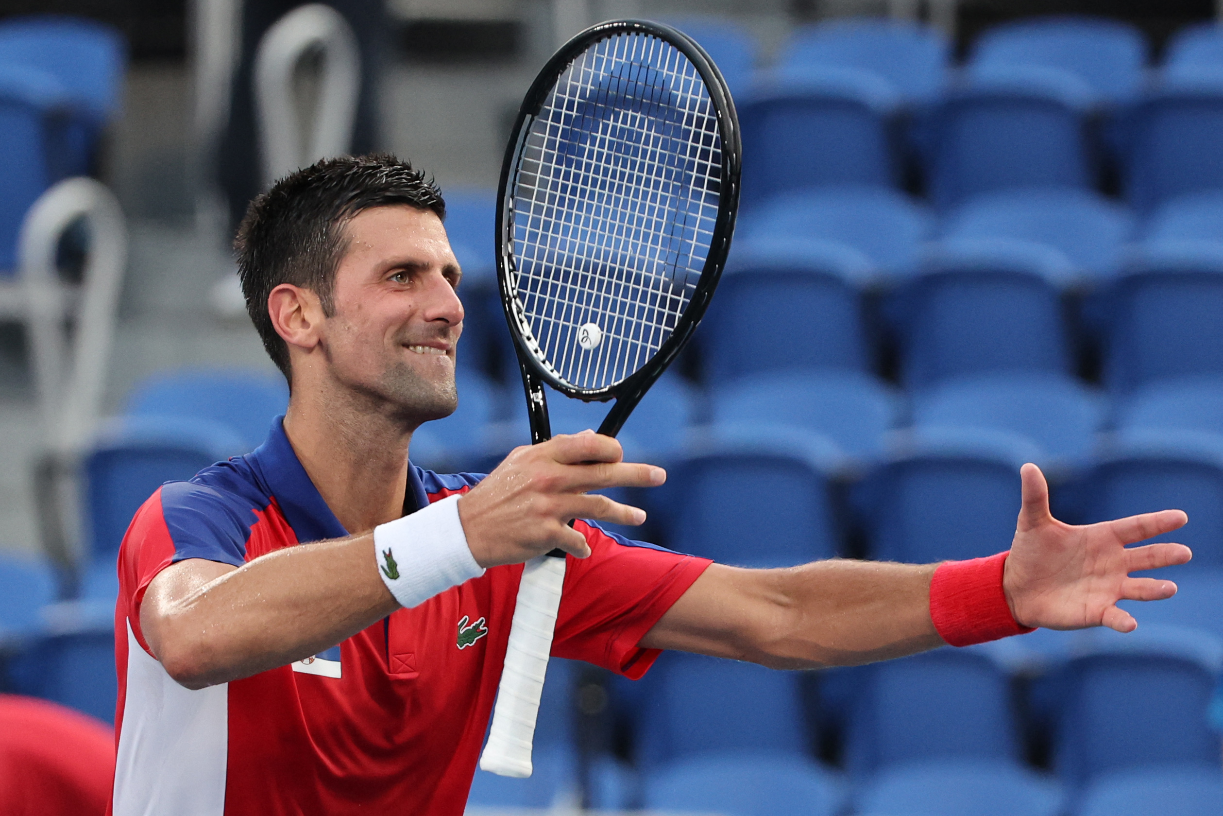 Serbia's Novak Djokovic celebrates beating Spain's Alejandro Davidovich Fokina during their Tokyo 2020 Olympic Games men's singles third round tennis match at the Ariake Tennis Park in Tokyo on July 28, 2021. (Photo by Giuseppe CACACE / AFP)