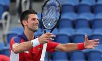Serbia's Novak Djokovic celebrates beating Spain's Alejandro Davidovich Fokina during their Tokyo 2020 Olympic Games men's singles third round tennis match at the Ariake Tennis Park in Tokyo on July 28, 2021. (Photo by Giuseppe CACACE / AFP)