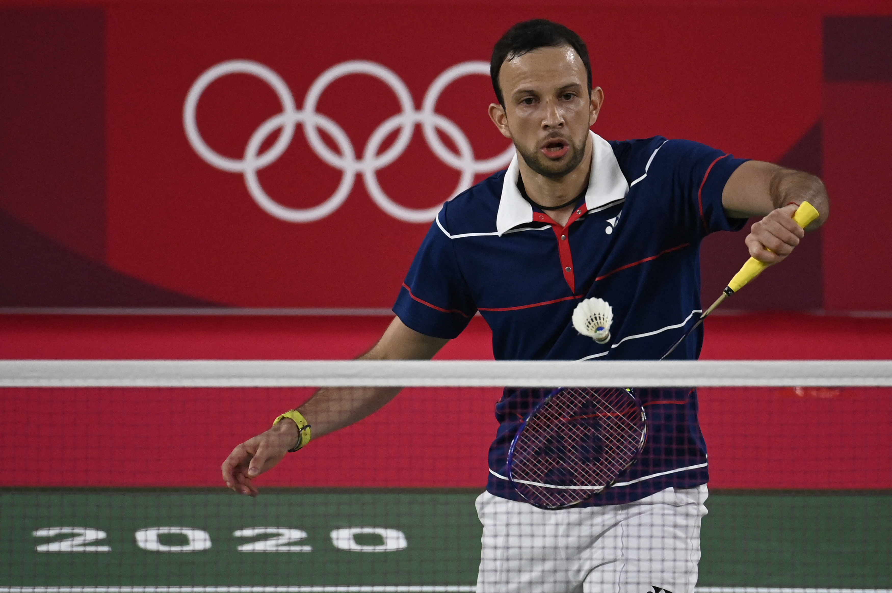 Guatemala's Kevin Cordon hits a shot to Hong Kong's Angus Ng Ka Long in their men's singles badminton group stage match during the Tokyo 2020 Olympic Games at the Musashino Forest Sports Plaza in Tokyo on July 28, 2021. (Photo by Alexander NEMENOV / AFP)