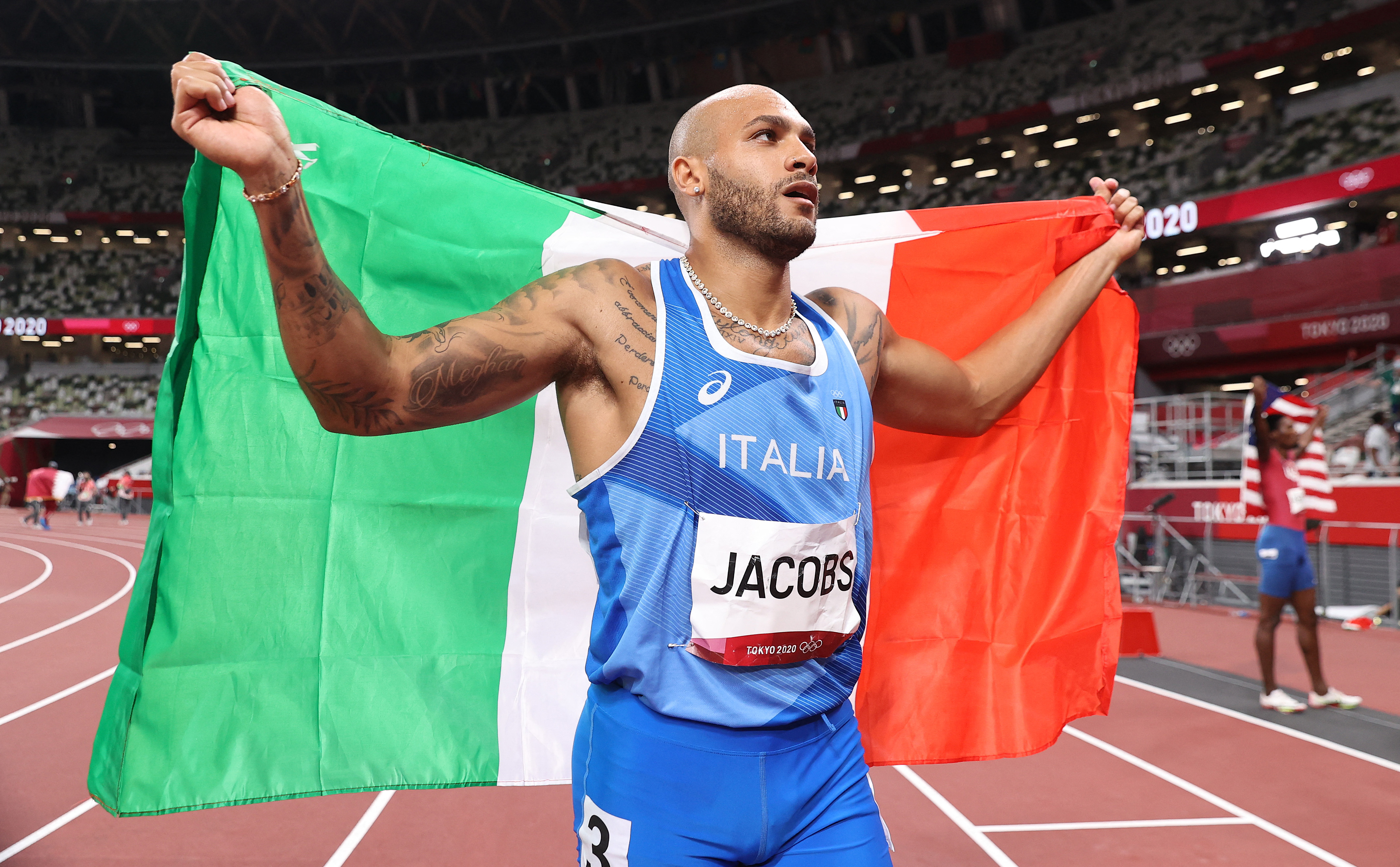 Italy's Lamont Marcell Jacobs celebrates after winning the men's 100m final during the Tokyo 2020 Olympic Games at the Olympic Stadium in Tokyo on August 1, 2021. (Photo by Cameron Spencer / POOL / AFP)