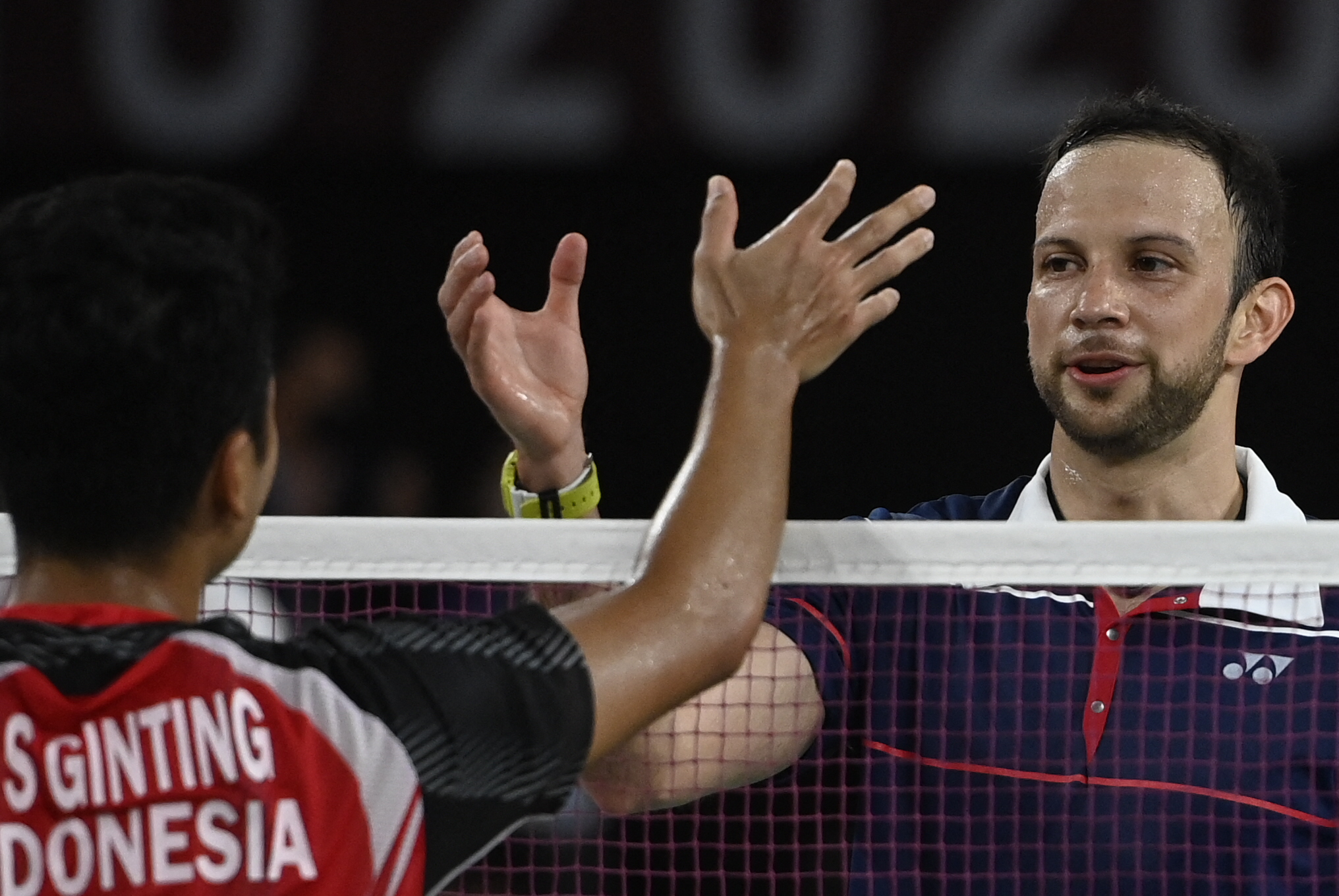 Indonesia's Anthony Sinisuka Ginting (L) greets Guatemala's Kevin Cordon after winning their men's singles badminton bronze medal match during the Tokyo 2020 Olympic Games at the Musashino Forest Sports Plaza in Tokyo on August 2, 2021. (Photo by Alexander NEMENOV / AFP)