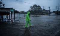 A man walks in a flooded street due to heavy rains caused by Hurricane Grace in Tecolutla, Veracruz, Mexico, on August 21, 2021. - Hurricane Grace lashed eastern Mexico with heavy rain and strong wind on Saturday, causing flooding, power blackouts and damage to homes as it gradually lost strength over the mountainous interior. (Photo by VICTORIA RAZO / AFP)
