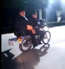 Policías trasladan a asaltante en Amatitlán, iban tres en una moto. (Foto Prensa Libre: captura de video)