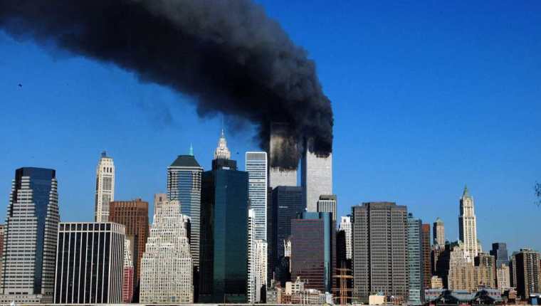 (FILES) In this file photo smoke billows from the twin towers of the World Trade Center in lower Manhattan, New York on September 11, 2001. - On the morning of Tuesday September 11, 2001, New Yorkers woke to crisp blue skies following a storm that had soaked America's northeastern seaboard the day before. The cloudless, beautiful sky was little portent of the dark, history-changing day that was to come but would remain etched on the memory of those involved. (Photo by HENNY RAY ABRAMS / AFP)