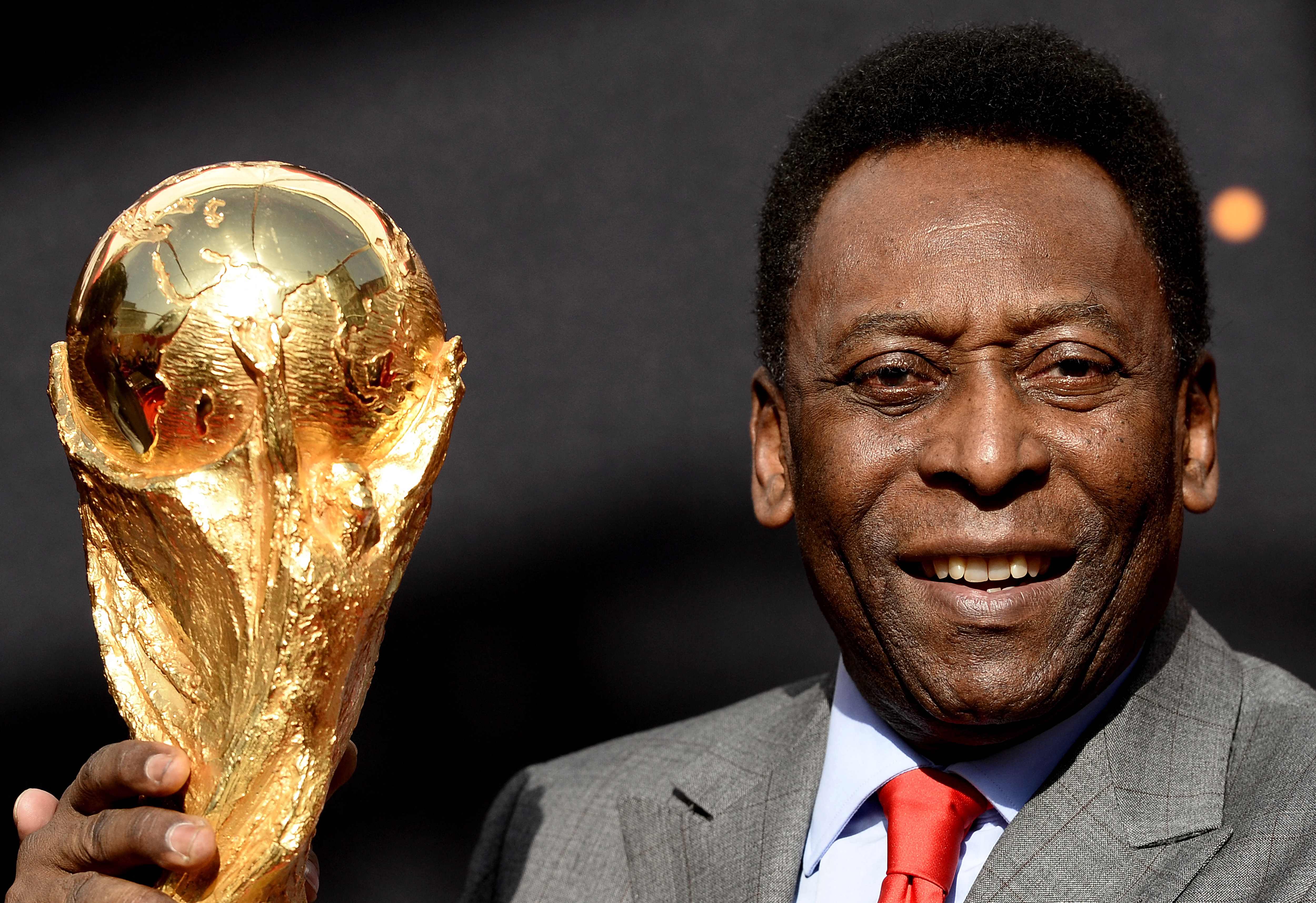 El exjugador brasileño Pelé posa junto al trofeo de FIFA afuera del Hotel de Ville en Paris. (Foto Prensa Libre: AFP)