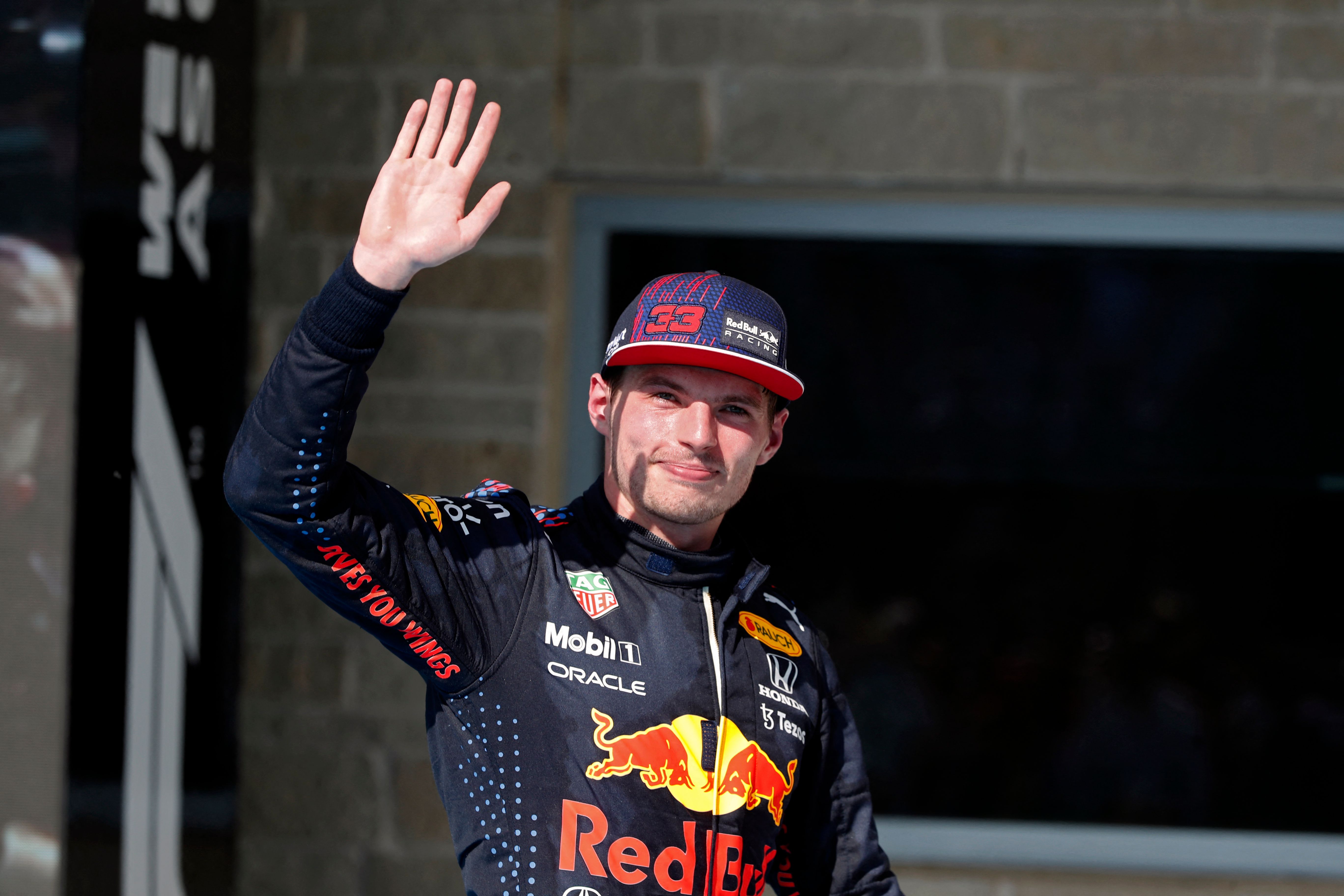 Red Bull's Dutch driver Max Verstappen waves on the podium after winning the Formula One United States Grand Prix at the Circuit of The Americas in Austin, Texas, on October 24, 2021. (Photo by Steven Tee / POOL / AFP)