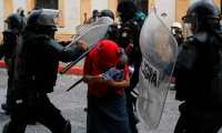 Riot police attack a demosntrator during a protest demanding the resignation of Guatemalan President Alejandro Giammattei, in Guatemala City on November 21, 2020. - The Vice President of Guatemala, Guillermo Castillo, asked President Alejandro Giammattei to resign together for