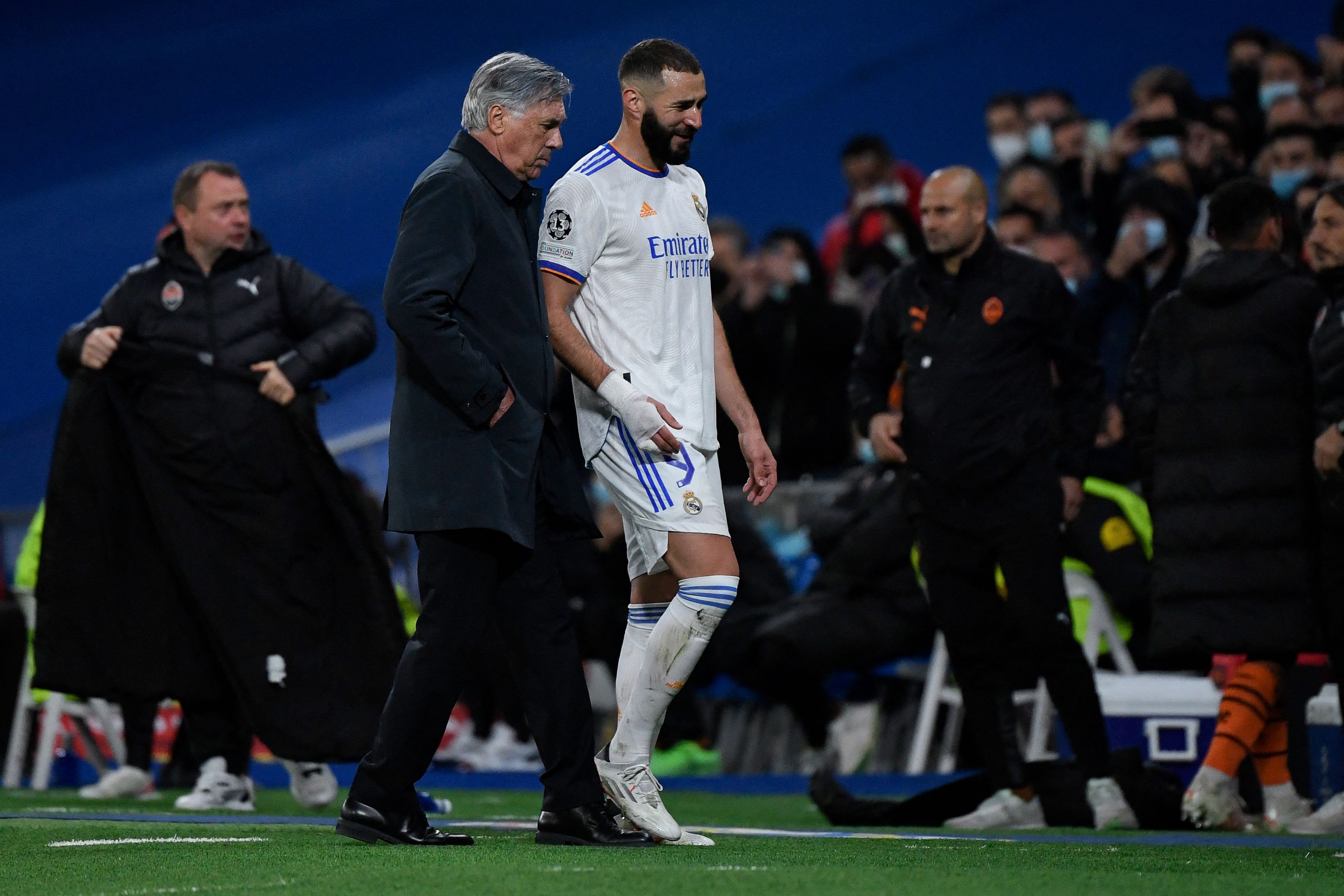 El entrenador del Real Madrid Karim Benzema (c) habla con Carlo Ancelotti en el partido de Champions ante el Shakhtar Donetsk. (Foto Prensa Libre: AFP)