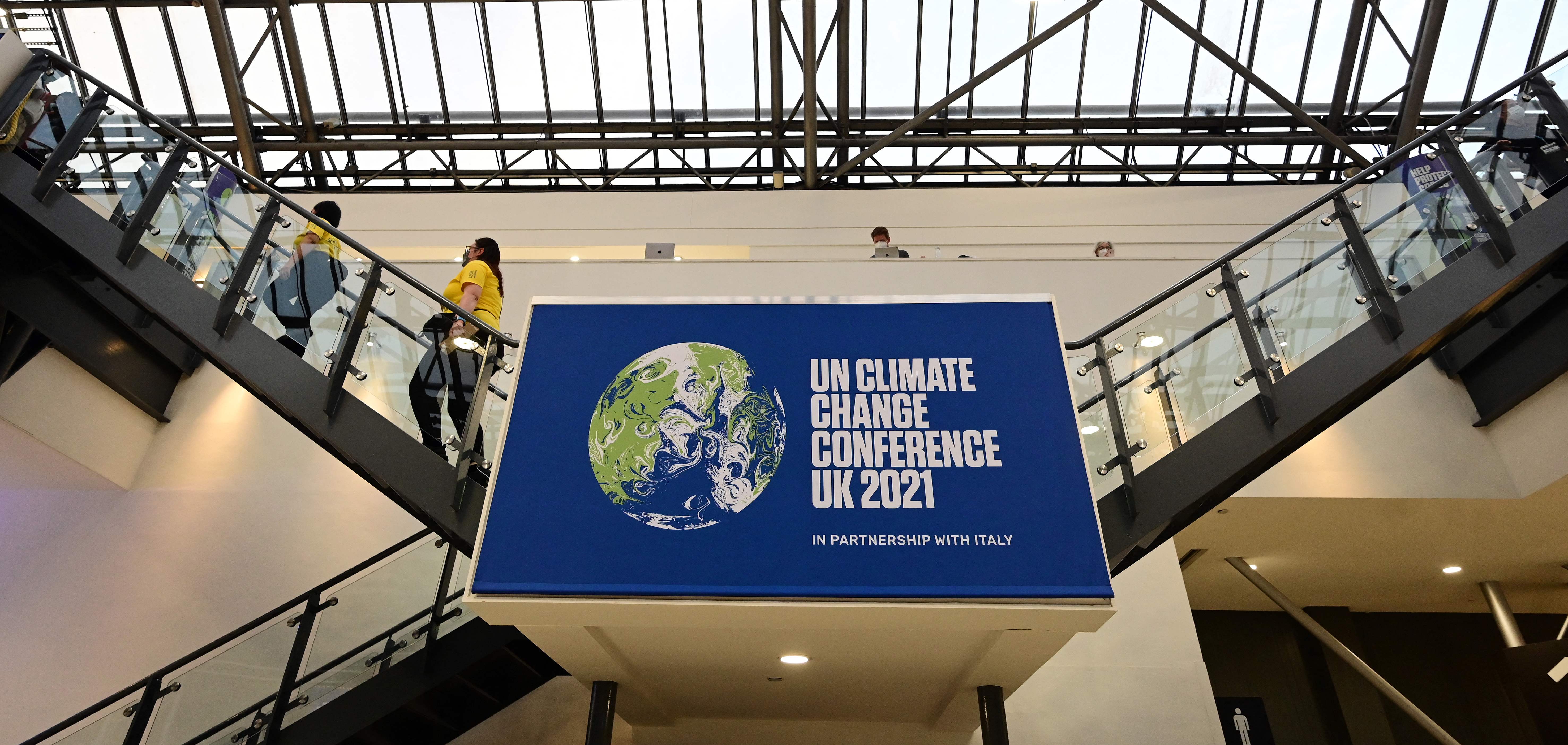 Signage inside the venue is seen on day five of the COP26 UN Climate Summit in Glasgow on November 4, 2021. - Global CO2 emissions mainly caused by burning fossil fuels are set to rebound in 2021 to levels seen before the Covid pandemic, according to an assessment that served as a 