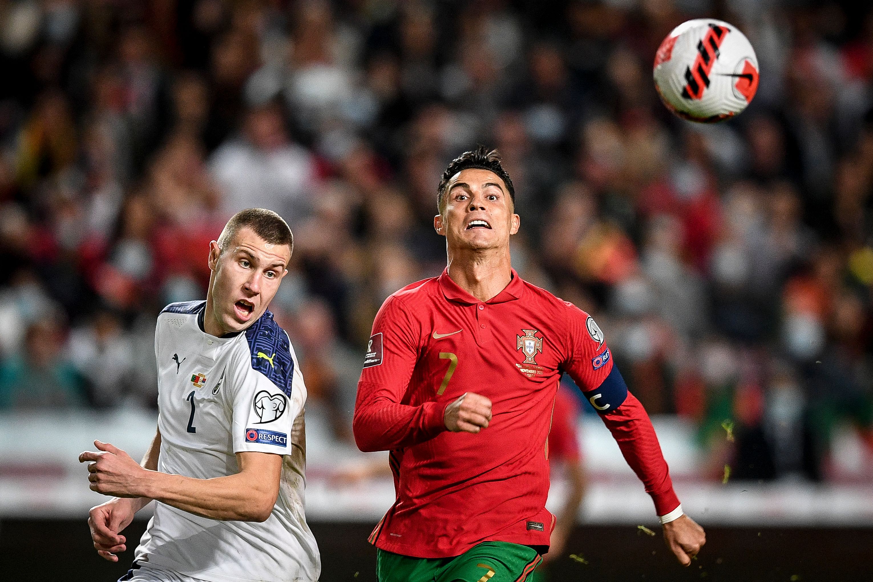 Serbia's defender Strahinja Pavlovic (L) fights for the ball with Portugal's forward Cristiano Ronaldo during the FIFA World Cup Qatar 2022 qualification group A football match between Portugal and Serbia, at the Luz stadium in Lisbon, on November 14, 2021. (Photo by PATRICIA DE MELO MOREIRA / AFP)
