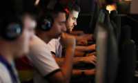 A team of gamers from North Macedonia play Counter-Strike (CSGO) during the finals of the 13th Esports World Championship in the Israeli Red Sea resort of Eilat on November 18, 2021. (Photo by AHMAD GHARABLI / AFP)