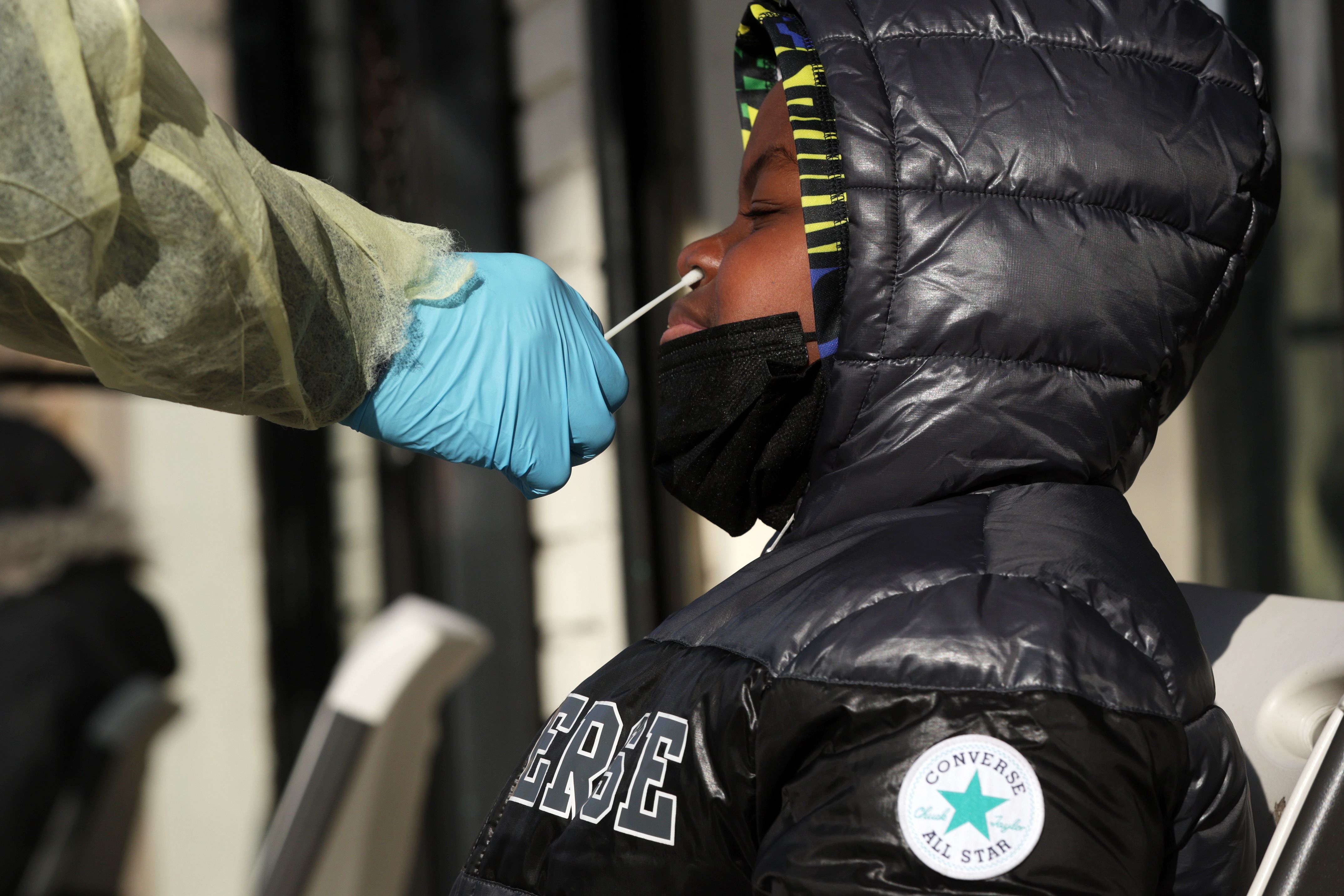 WASHINGTON, DC - DECEMBER 23: A patient takes a COVID test outside District Urgent Care on December 23, 2021 in Washington, DC. The City of District of Columbia is distributing free test kits to local residents prior to the holidays as COVID case numbers have surged to a new high. Alex Wong/Getty Images/AFP == FOR NEWSPAPERS, INTERNET, TELCOS & TELEVISION USE ONLY ==