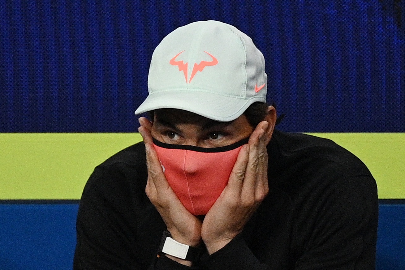 Melbourne (Australia).- (FILE) Rafael Nadal of Team Spain, wearing a protective face mask, watches teammate Pablo Carreno Busta playing Fabio Fignini of Italy during their semi final match at the ATP Cup tennis tournament at Melbourne Park in Melbourne, Australia, 06 February 2021 (reissued on 20 December 2021). 35-year-old Rafael Nadal has tested positive for Covid-19 after his comeback from injury in his match against Andy Murray of Britain at the Mubadala World Tennis Championship in Abu Dhabi. Rafael Nadal tests positive for Covid-19 (Tenis, Italia, España, Reino Unido) EFE/EPA/DEAN LEWINS AUSTRALIA AND NEW ZEALAND OUT *** Local Caption *** 56674863