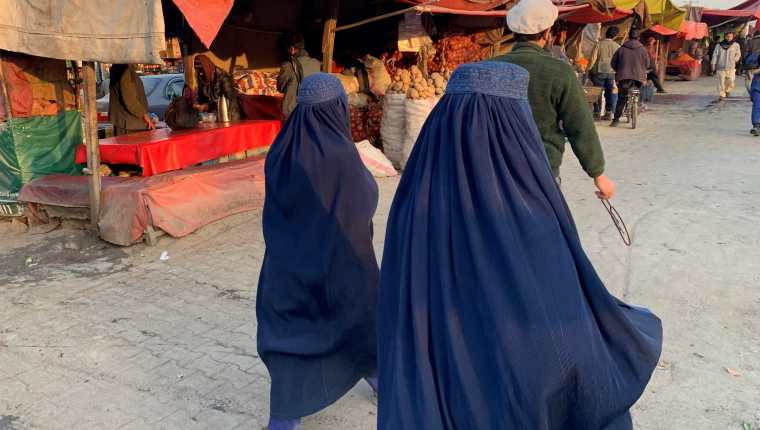 Dos mujeres caminan por el mercado de Kabul el pasado 11 de diciembre, previo a las nuevas medidas que restringen, aún más, los derechos de las mujeres. Fotografía: EFE.