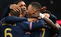 Paris Saint-Germain's French forward Kylian Mbappe (R) celebrates with teammates after scoring a goal during the French L1 football match between Paris Saint-Germain (PSG) and AS Monaco (ASM) at the Parc des Princes stadium in Paris, on December 12, 2021. (Photo by FRANCK FIFE / AFP)