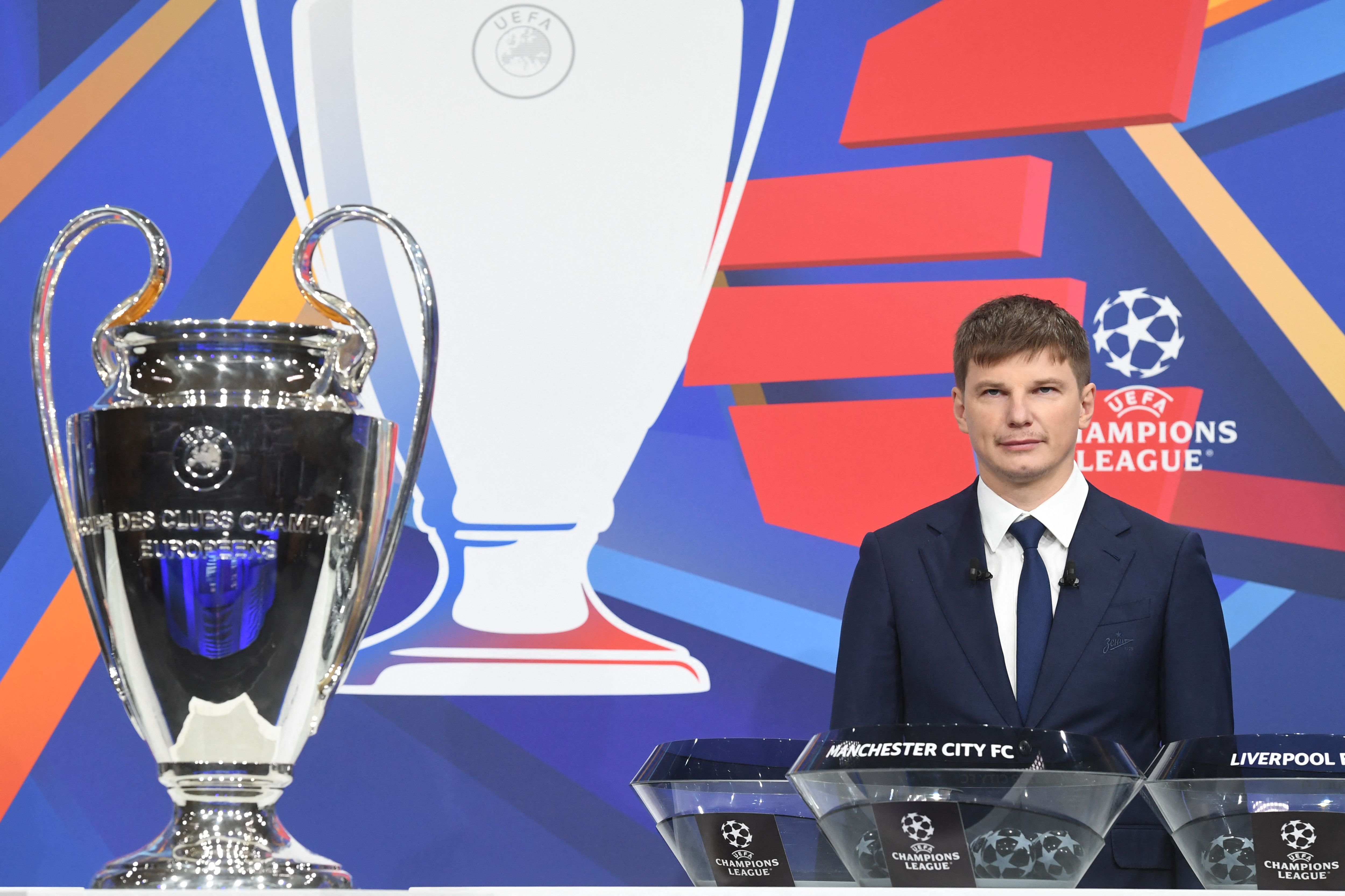 In this handout picture released by the UEFA, Russian former international forward Andrey Arshavin poses by the trophy during the Champions League round of 16 draw at the UEFA headquarters in Nyon, on December 13, 2021. - The first legs are scheduled for 15/16/22/23 February, with the second legs on 8/9/15/16 March. (Photo by Richard JUILLIART / UEFA / AFP) / RESTRICTED TO EDITORIAL USE - MANDATORY CREDIT 