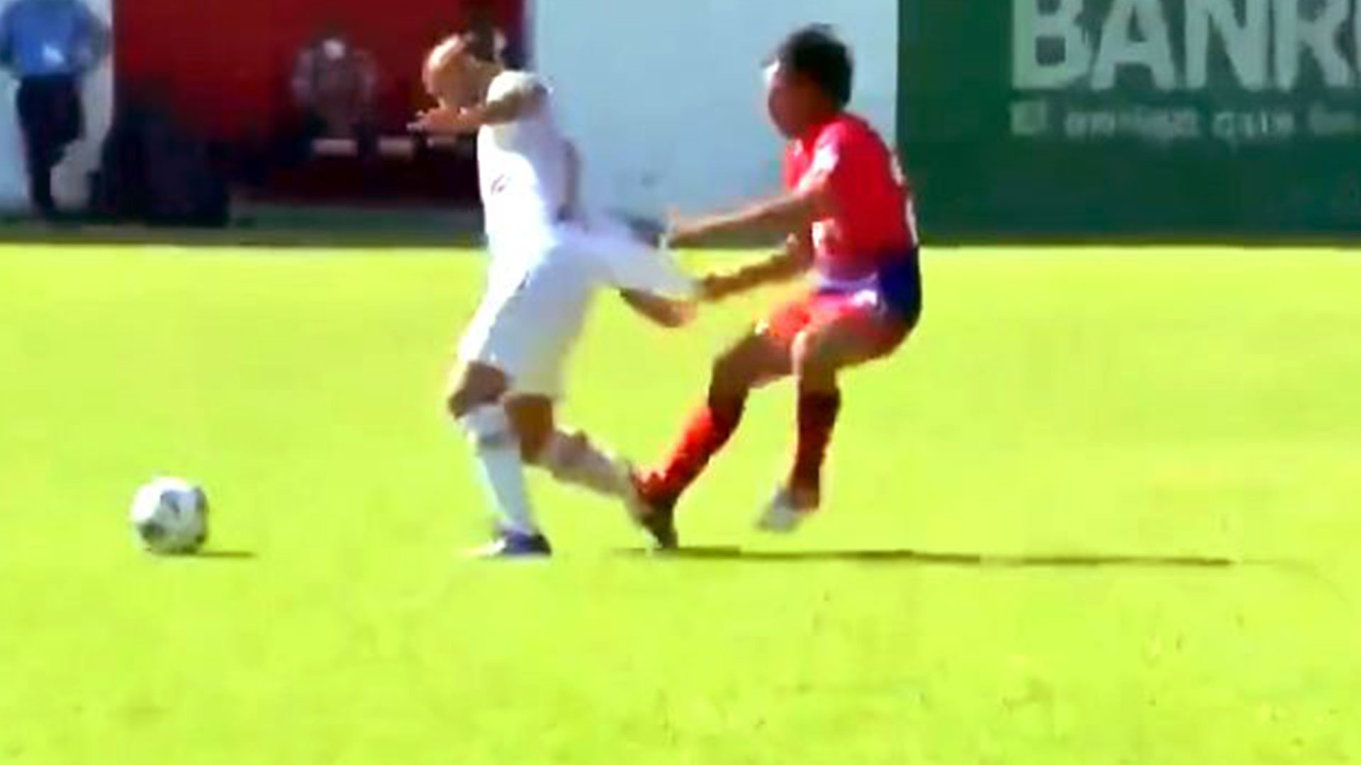 El jugador de Comunicaciones José Contreras (blanco) sufre un fuerte jalón por parte de Julián Priego. (Foto Prensa Libre: Twitter)