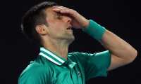 (FILES) This file photo taken on February 16, 2021 shows Serbia's Novak Djokovic reacting after losing a point against Germany's Alexander Zverev during their men's singles quarter-final match on day nine of the Australian Open tennis tournament in Melbourne. - Australia's government cancelled Novak Djokovic's visa for a second time on January 14, 2022 as it sought to deport the superstar over his Covid-19 vaccine status. (Photo by Brandon MALONE / AFP) / -- IMAGE RESTRICTED TO EDITORIAL USE - STRICTLY NO COMMERCIAL USE --