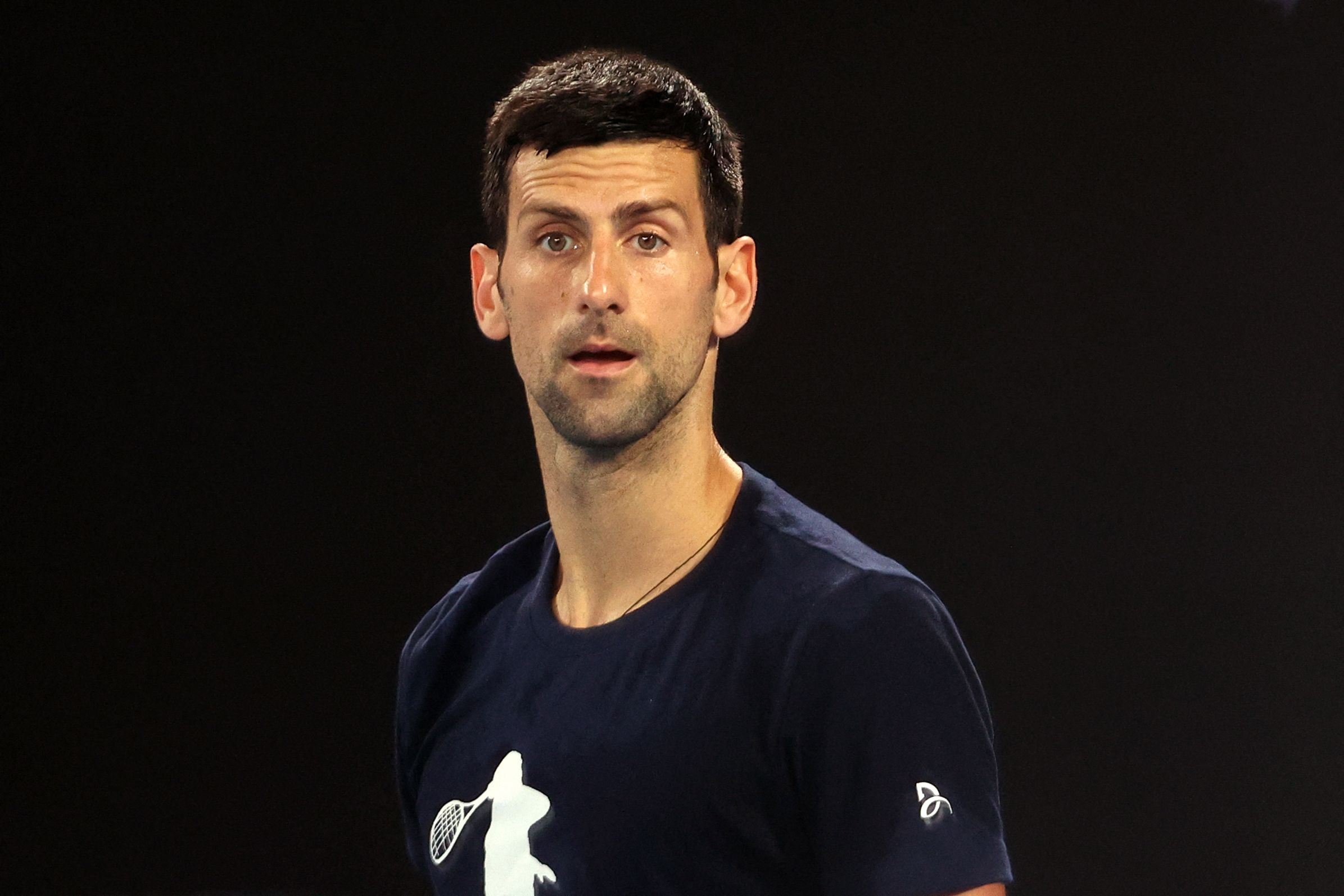 Novak Djokovic of Serbia attends a practice session ahead of the Australian Open tennis tournament in Melbourne on January 14, 2022. (Photo by MARTIN KEEP / AFP) / --IMAGE RESTRICTED TO EDITORIAL USE - NO COMMERCIAL USE--