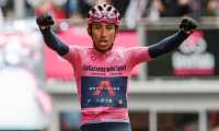 (FILES) In this file photo taken on May 24, 2021, wverall leader Team Ineos rider Colombia's Egan Bernal celebrates as he crosses the finish line to win the 16th stage of the Giro d'Italia 2021 cycling race, 153km between Sacile and Cortina d'Ampezzo in Italy. - Former Tour de France winner Egan Bernal was "conscious" and "stable" in hospital following a training accident near his home town in Colombia, his cycling team Ineos Grenadiers said on Monday January 24, 2022. (Photo by Luca BETTINI / AFP)