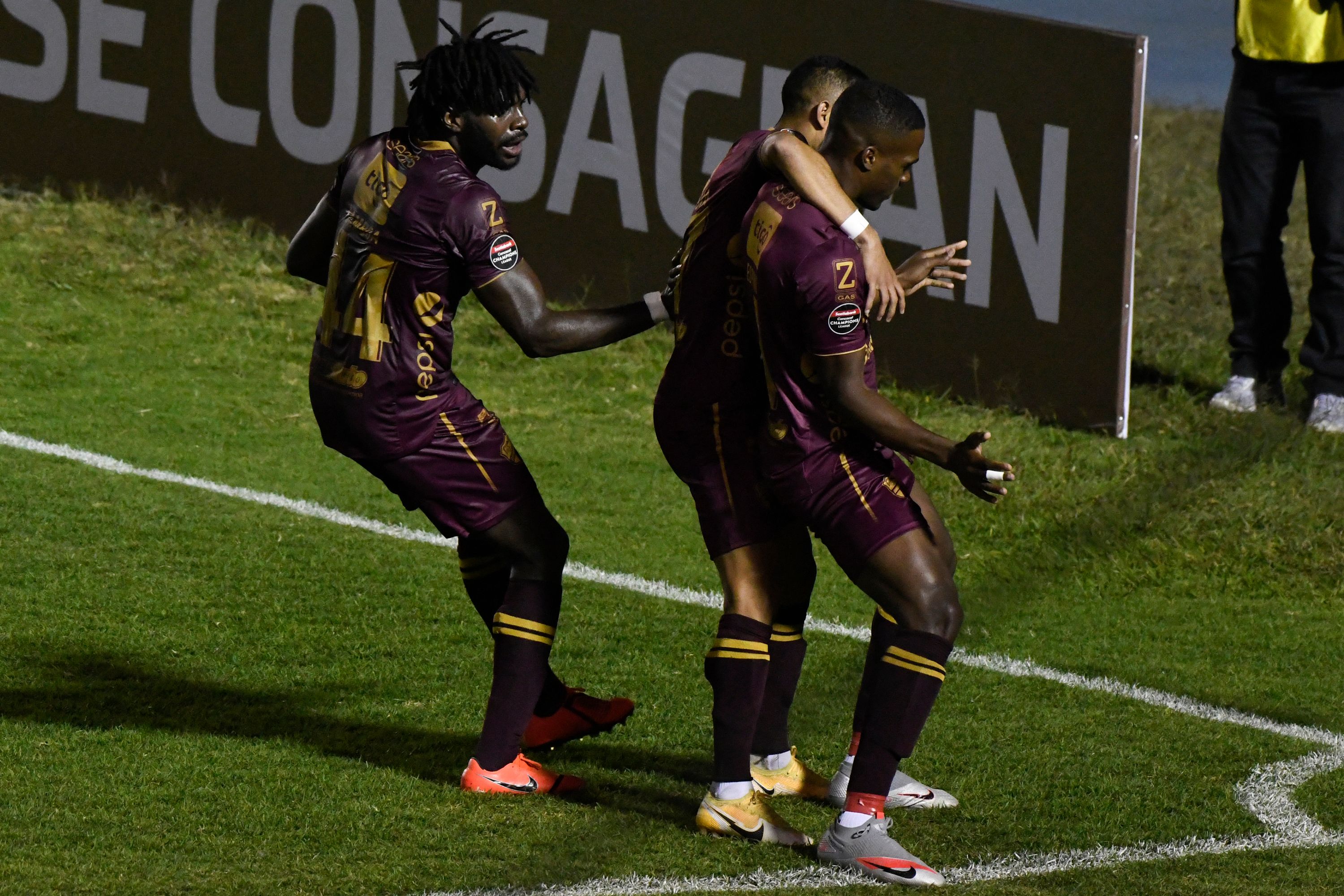 Guatemala's Comunicaciones Karel Espino (R) celebrates with teammates after scoring against U.S. Rapids during the Concacaf League football match at Doroteo Guamuch stadium in Guatemala City, on February 17, 2022. (Photo by Johan ORDONEZ / AFP)
