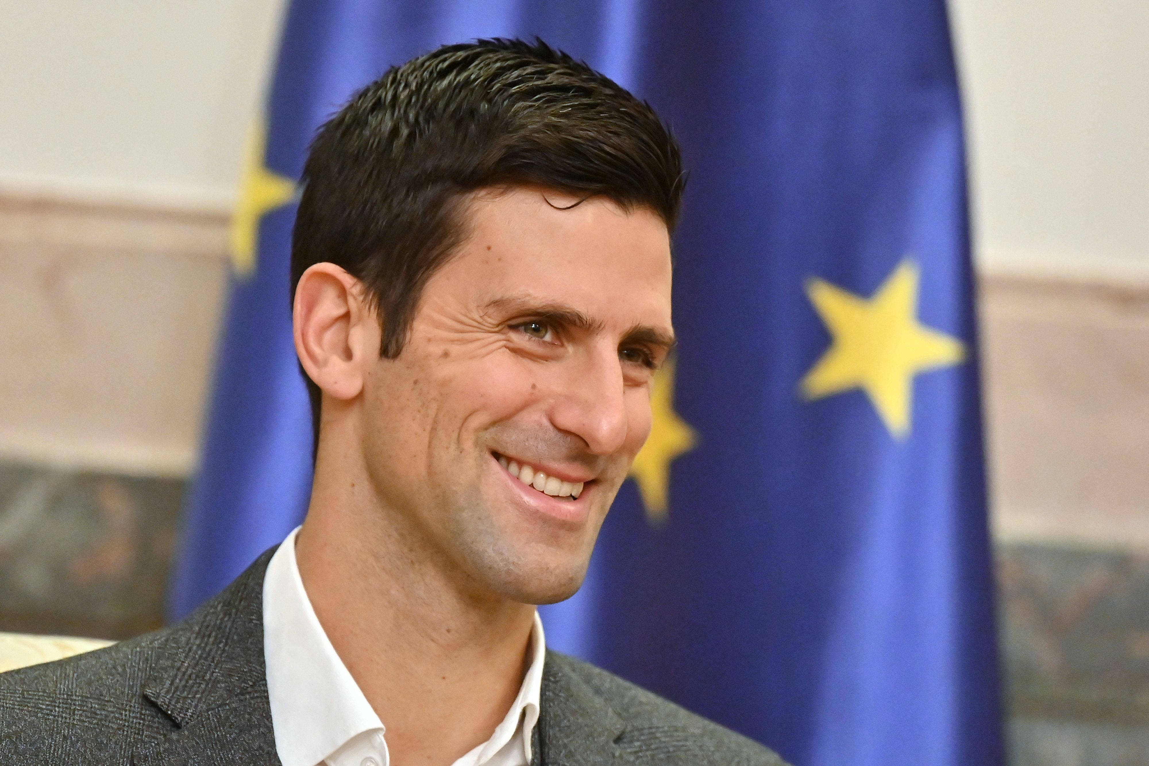 Serbian tennis player Novak Djokovic looks on as he attends a meeting with Serbian President in Belgrade on February 3, 2022. - The 34-year-old world number one was unable to play in the Australian Open after being deported over Covid-19 vaccination issues, despite initially receiving an exemption from officials based on an positive PCR test weeks ahead of the tournament. (Photo by Andrej ISAKOVIC / AFP)