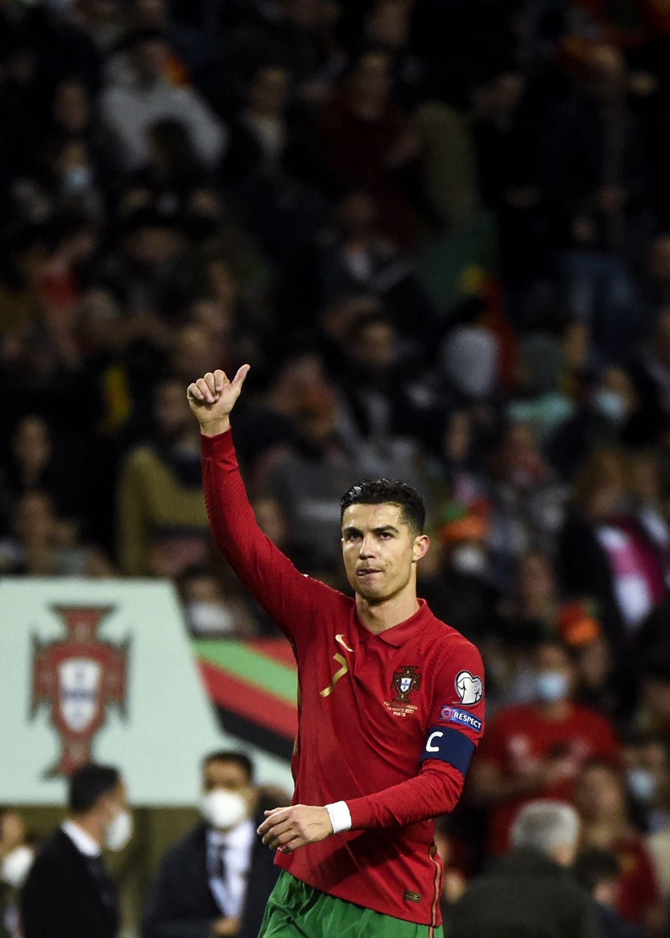 Portugal's forward Cristiano Ronaldo waves to supporters at the end of the World Cup 2022 qualifying semi-final first leg football match between Portugal and Turkey at the Dragao stadium in Porto on March 24, 2022. (Photo by MIGUEL RIOPA / AFP)
