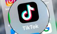 (FILES) This file photo taken on March 24, 2022 shows logo of the networking application TikToK displayed on a tablet in Lille, northern France. - The networking application TikTok says suspending posting of new videos from Russia. (Photo by DENIS CHARLET / AFP)
