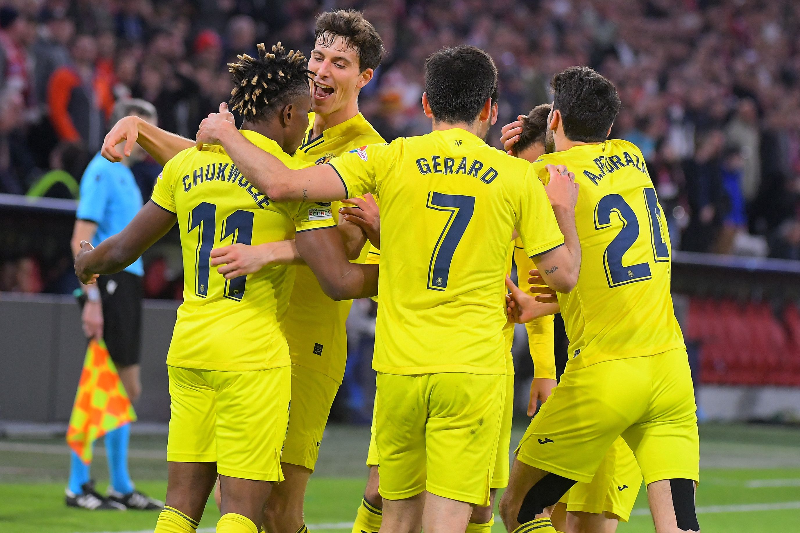 Villarreal's Nigerian midfielder Samuel Chukwueze (L) celebrates scoring the 1-1 with his team-mates during the UEFA Champions League quarter-final, second leg football match FC Bayern Munich v FC Villarreal in Munich, southern Germany on April 12, 2022. (Photo by Jose Jordan / AFP)