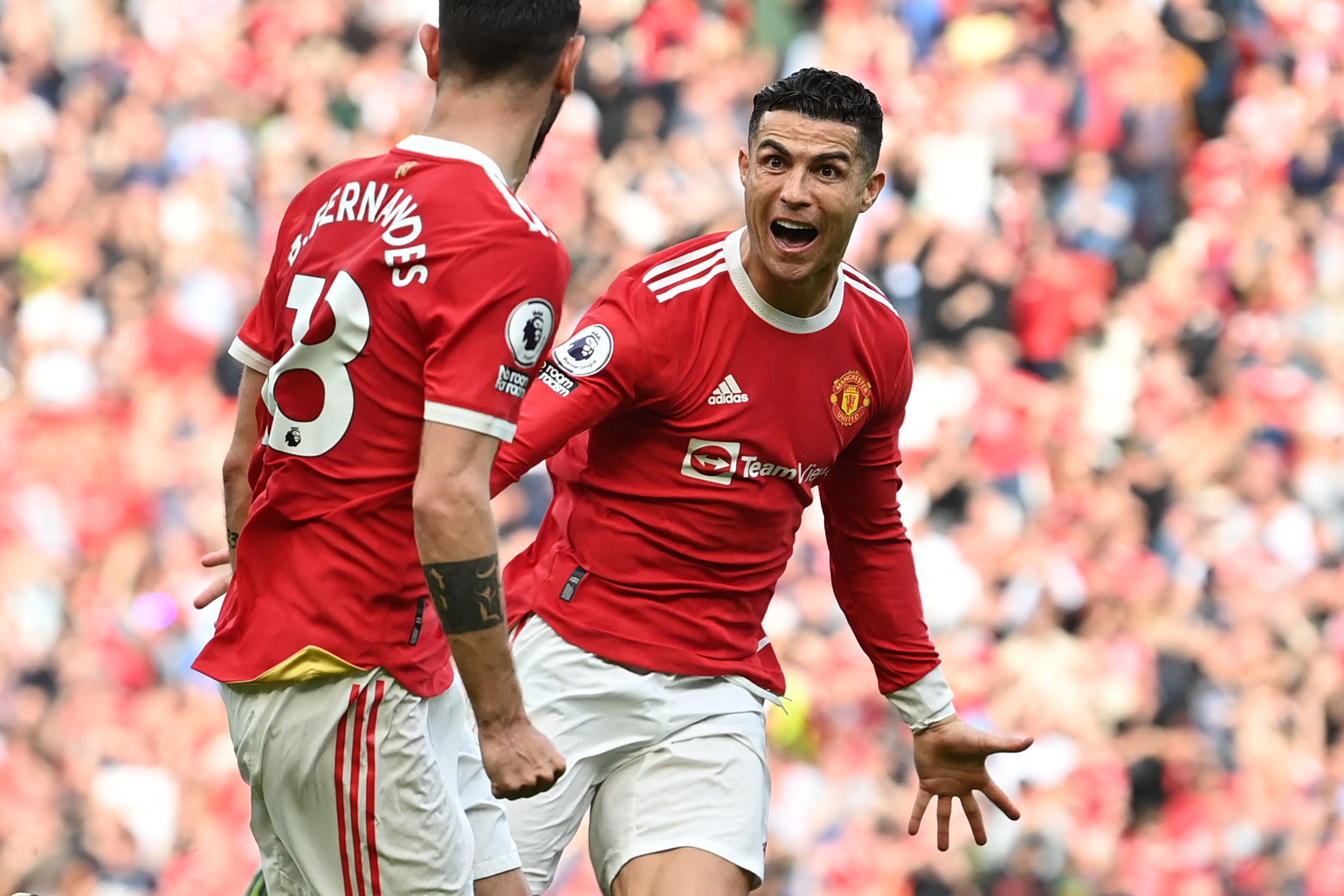 Manchester United's Portuguese striker Cristiano Ronaldo celebrates after scoring his third goal during the English Premier League football match between Manchester United and Norwich City at Old Trafford in Manchester, north west England, on April 16, 2022. (Photo by Paul ELLIS / AFP) / RESTRICTED TO EDITORIAL USE. No use with unauthorized audio, video, data, fixture lists, club/league logos or 'live' services. Online in-match use limited to 120 images. An additional 40 images may be used in extra time. No video emulation. Social media in-match use limited to 120 images. An additional 40 images may be used in extra time. No use in betting publications, games or single club/league/player publications. /