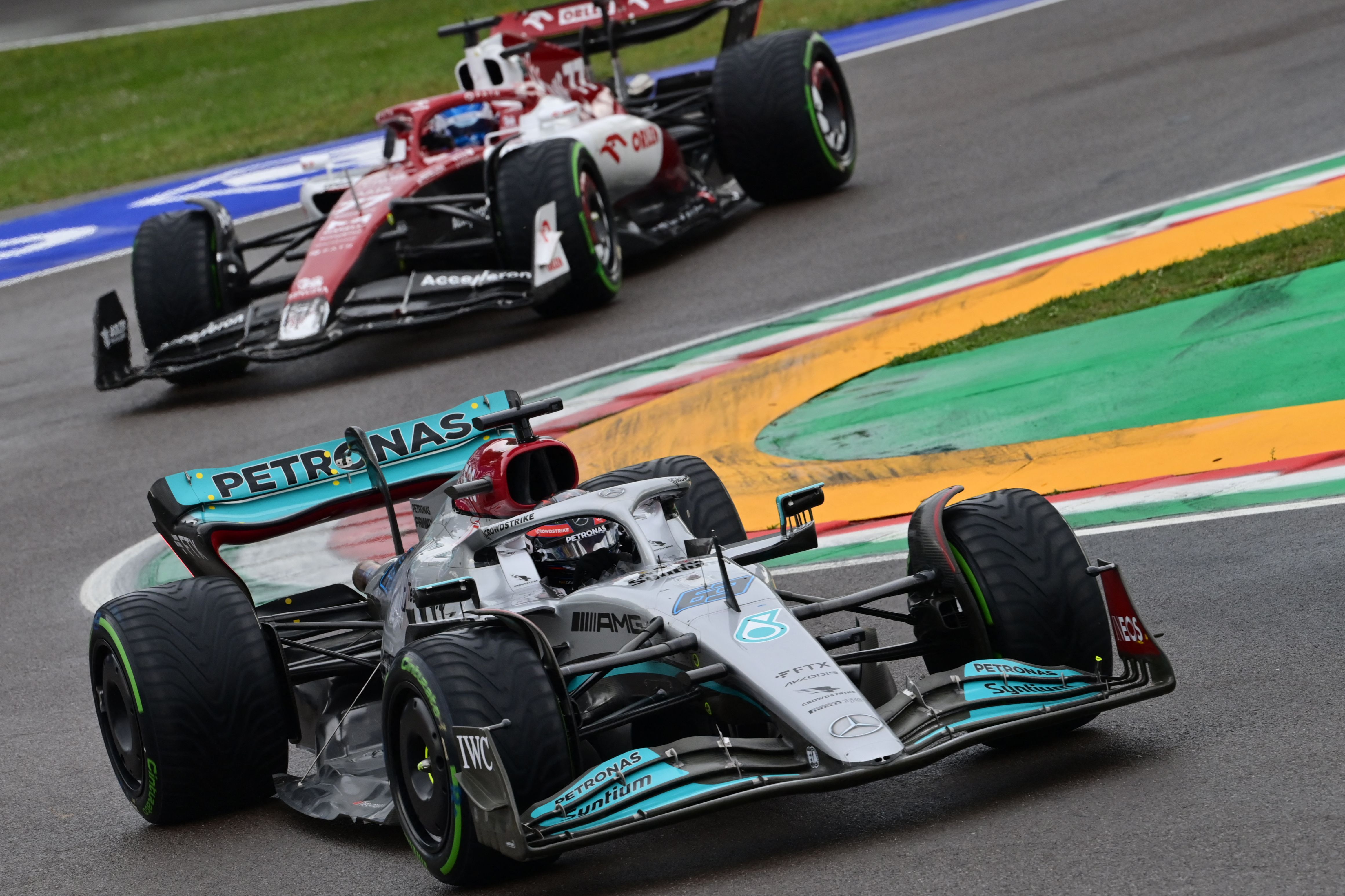 Mercedes' British driver George Russell followed by Alfa Romeo's Finnish driver Valtteri Bottas steer during the Emilia Romagna Formula One Grand Prix at the Autodromo Internazionale Enzo e Dino Ferrari race track in Imola, Italy, on April 24, 2022. (Photo by MIGUEL MEDINA / AFP)