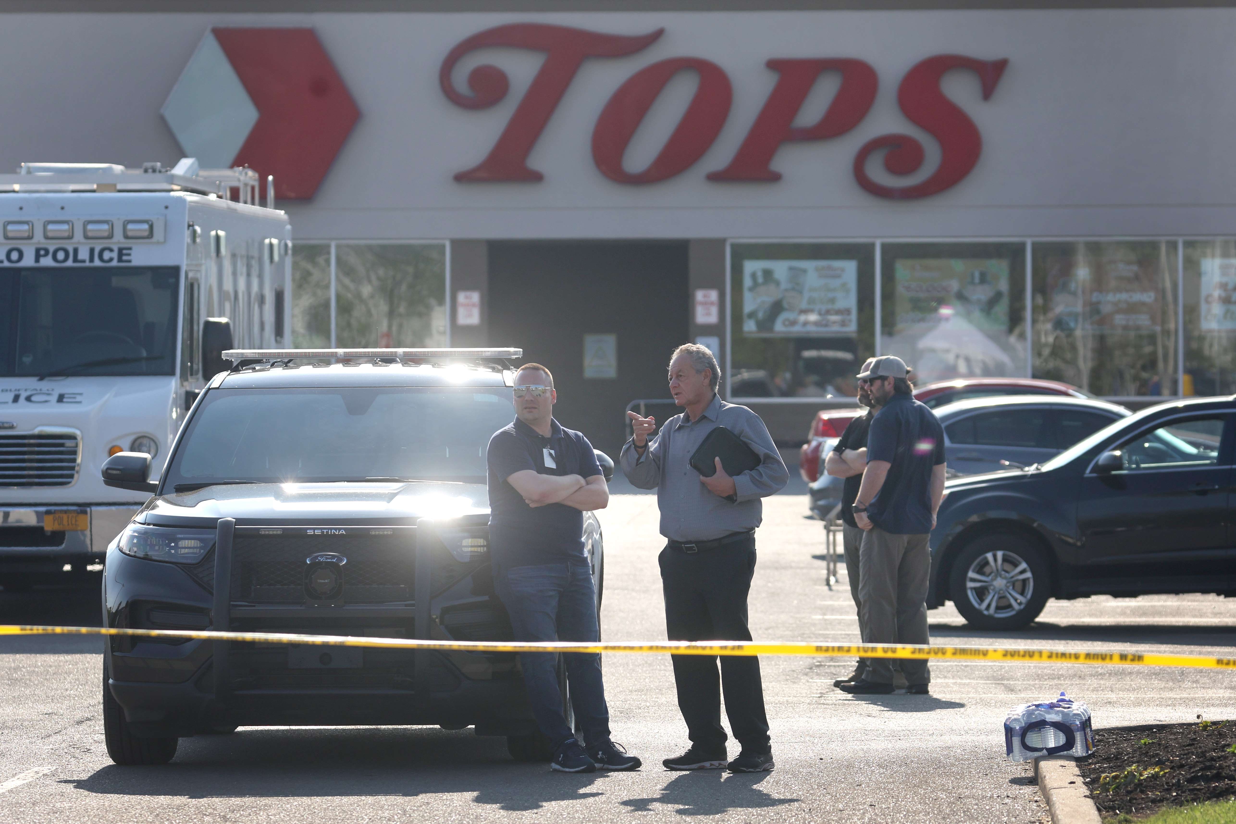 BUFFALO, NEW YORK - MAY 15: Police continue investigating at Tops market on May 15, 2022 in Buffalo, New York. Yesterday a gunman opened fire at the store, killing ten people and wounding another three. Suspect Payton Gendron was taken into custody and charged with first degree murder. U.S. Attorney Merrick Garland released a statement, saying the US Department of Justice is investigating the shooting 