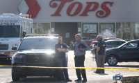 BUFFALO, NEW YORK - MAY 15: Police continue investigating at Tops market on May 15, 2022 in Buffalo, New York. Yesterday a gunman opened fire at the store, killing ten people and wounding another three. Suspect Payton Gendron was taken into custody and charged with first degree murder. U.S. Attorney Merrick Garland released a statement, saying the US Department of Justice is investigating the shooting "as a hate crime and an act of racially-motivated violent extremism".   Scott Olson/Getty Images/AFP
== FOR NEWSPAPERS, INTERNET, TELCOS & TELEVISION USE ONLY ==