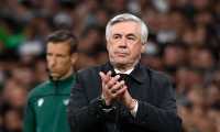 Real Madrid's Italian coach Carlo Ancelotti applauds during the UEFA Champions League semi-final second leg football match between Real Madrid CF and Manchester City at the Santiago Bernabeu stadium in Madrid on May 4, 2022. (Photo by PIERRE-PHILIPPE MARCOU / AFP)