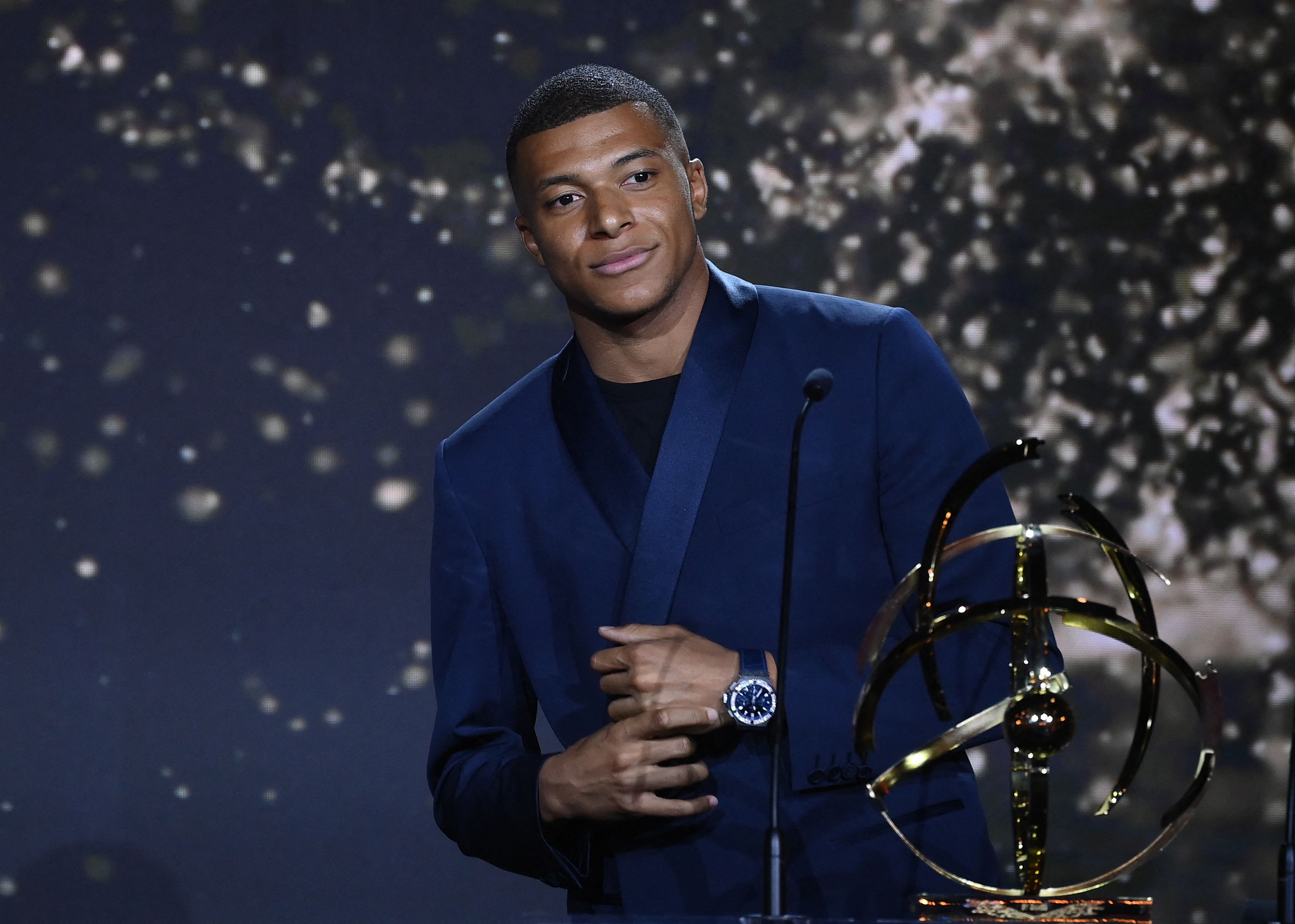 Paris Saint-Germain's French forward Kylian MBappe receives the Best Ligue 1 Player award during the TV show on May 15, 2022 in Paris, as part of the 30th edition of the UNFP (French National Professional Football players Union) trophy ceremony. (Photo by FRANCK FIFE / AFP)