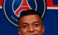 Paris Saint-Germain's French forward Kylian Mbappe poses at the end of a press conference at the Parc des Princes stadium in Paris on May 23, 2022, two days after the club won the Ligue 1 title for a record-equalling tenth time and its superstar striker Mbappe chose to sign a new contract until 2025 at PSG rather than join Real Madrid. (Photo by FRANCK FIFE / AFP)