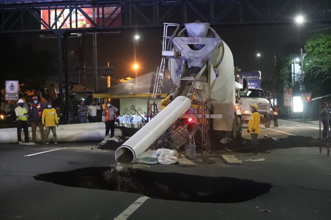 El agujero que se formó en el km 15 de la ruta al Pacífico es rellenado con lodocreto. (Foto Prensa Libre: Roberto López)