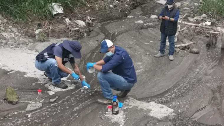 Personal de la Municipalidad de Mixco y de Amsa toman muestras en el río de San Cristóbal para tratar de identificar la fuente de olores a químico que hay en el área. (Foto Prensa Libre: Facebook de Neto Bran)