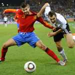 (FILES) In this file photo taken on July 7, 2010 Spain's defender Gerard Pique (L) and Germany's striker Miroslav Klose fight for the ball during the 2010 World Cup semi-final football match Germany vs. Spain at Moses Mabhida stadium in Durban. NO PUSH TO MOBILE / MOBILE USE SOLELY WITHIN EDITORIAL ARTICLE (Photo by Pierre-Philippe MARCOU / AFP)