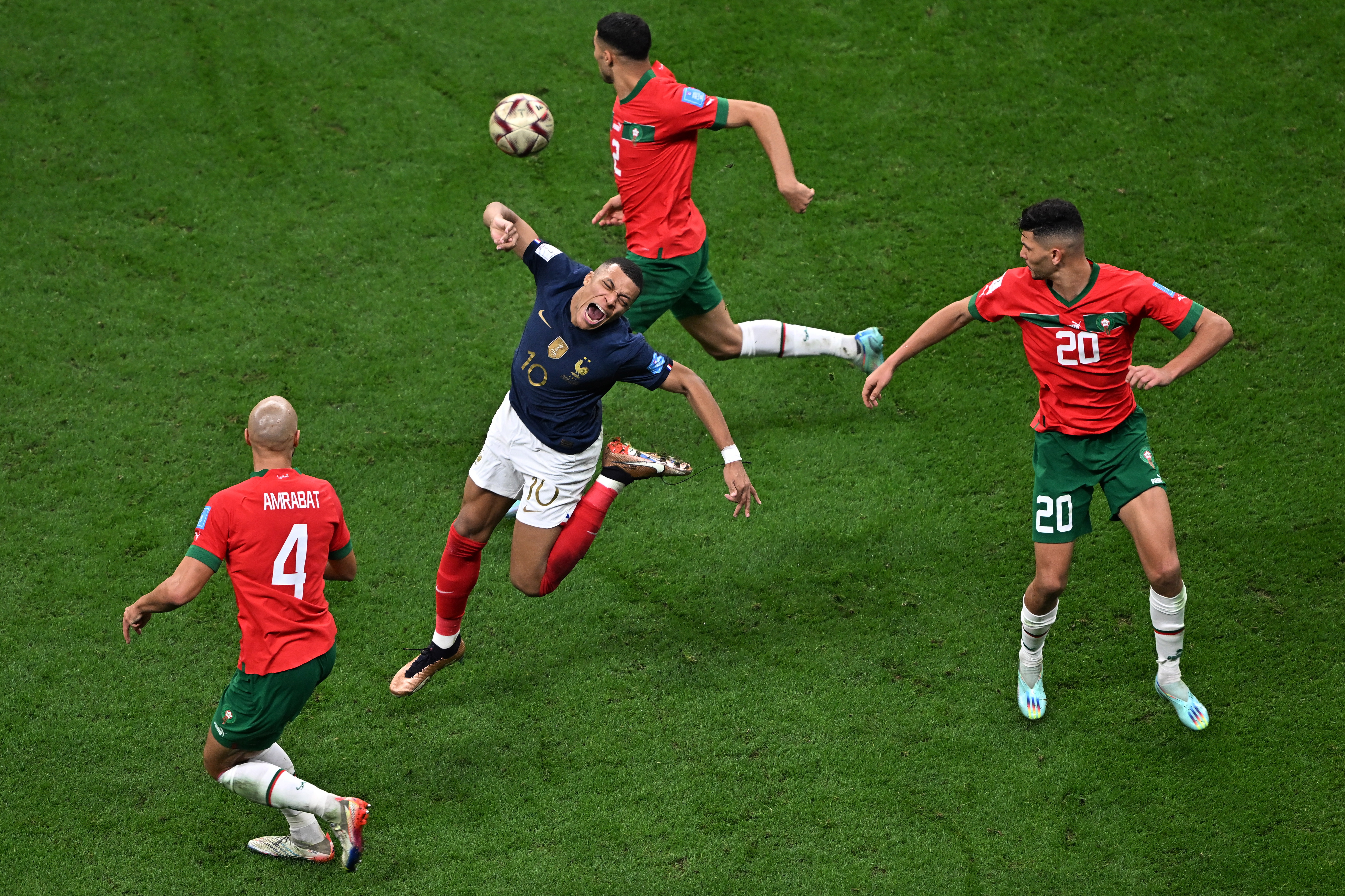 -PHOTODAY- EA3182. AL KHOR (QATAR), 12/14/2022.- Kylian Mbappe of France disputes the ball with Achraf Hakimi (top), Sofyan Amrabat (l), and Achraf Dari of Morocco, today, during the semi-final of the FIFA World Cup Qatar 2022 between France and Morocco, at the Al Bayt stadium in the city of Al Khor (Qatar). EFE/ Noushad Thekkayil
