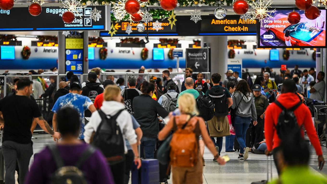 Decenas de personas esperan información en el Aeropuerto Internacional de Miami, Florida, pues este lunes al menos 13 vuelos han sido cancelados a causa del mal tiempo. (Foto Prensa Libre: AFP)
