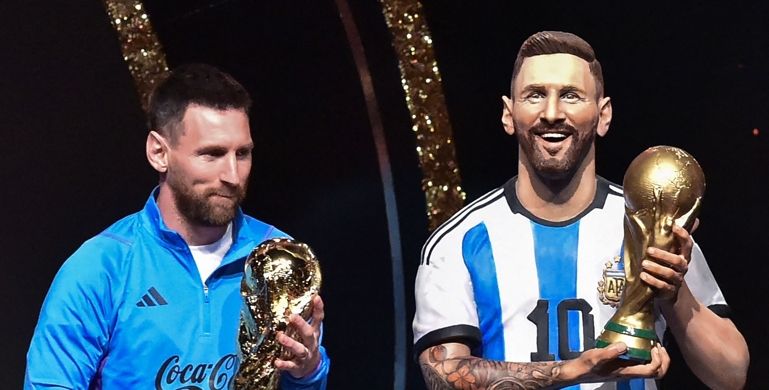 El delantero argentino Lionel Messi se encuentra junto a una estatua de sí mismo durante un homenaje de Conmebol a Argentina por su título de la Copa Mundial de Qatar 2022, celebrado antes del sorteo de las fases de grupos de los torneos de fútbol Libertadores y Sudamericana, en la sede de Conmebol. Foto Prensa Libre (AFP)