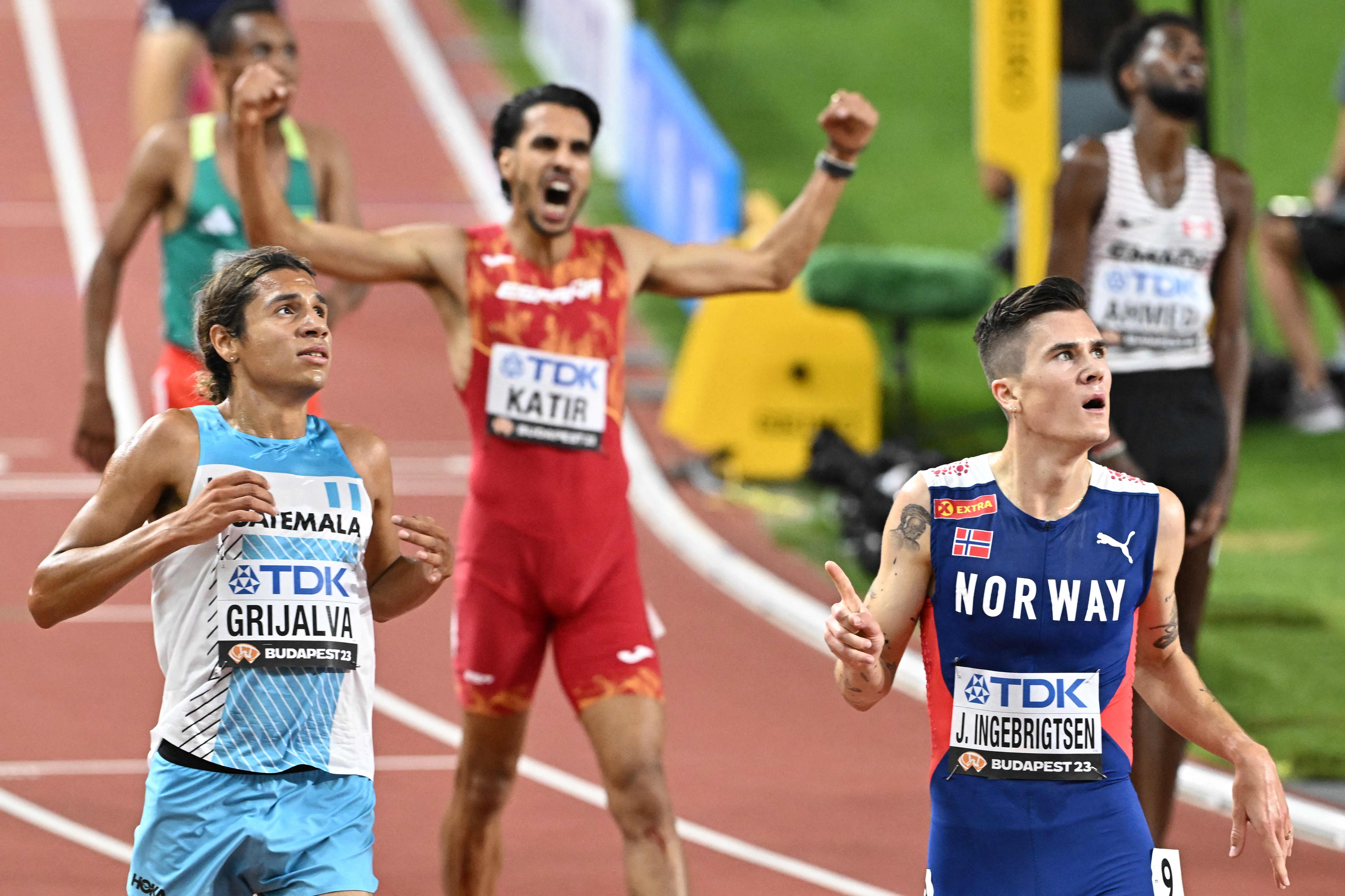Norway's Jakob Ingebrigtsen, Spain's Mohamed Katir, and Guatemala's Luis Grijalva react after the men's 5000m final during the World Athletics Championships at the National Athletics Centre in Budapest on August 27, 2023. (Photo by Attila KISBENEDEK / AFP)